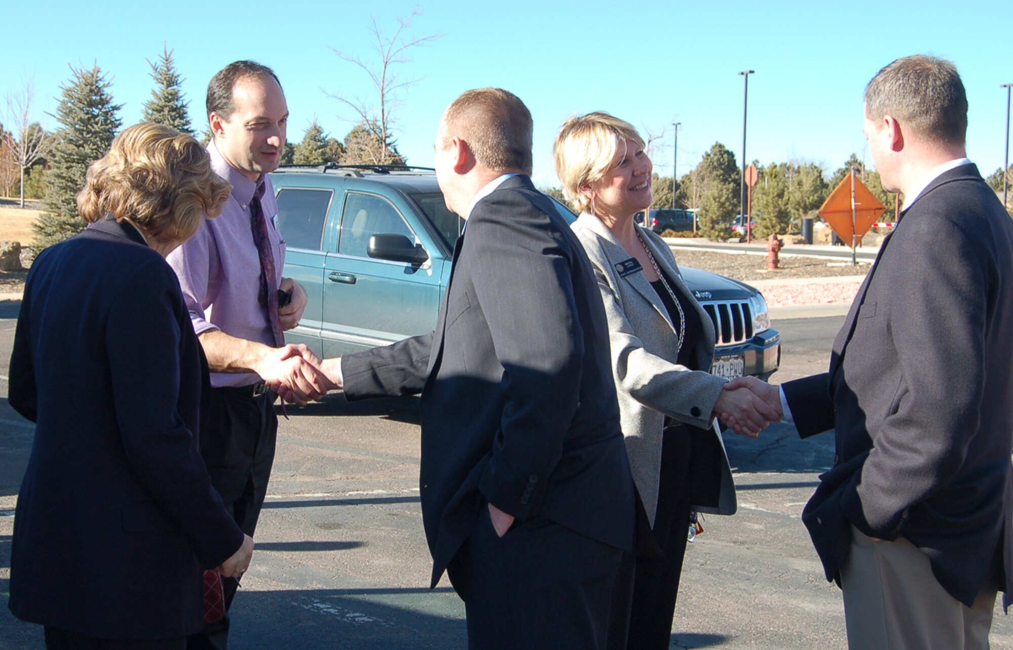 Arriving state legislators greet Mr. Al Strait, 21st Space Wing director of staff, and Mr. Jeff Bohn, 21st SW public affairs, on Peterson Feb. 19. Members of the Colorado House’s state, veteran and military affairs committee spent the afternoon at Peterson, learning about the base and its missions. (U.S. Air Force photo/Corey Dahl)