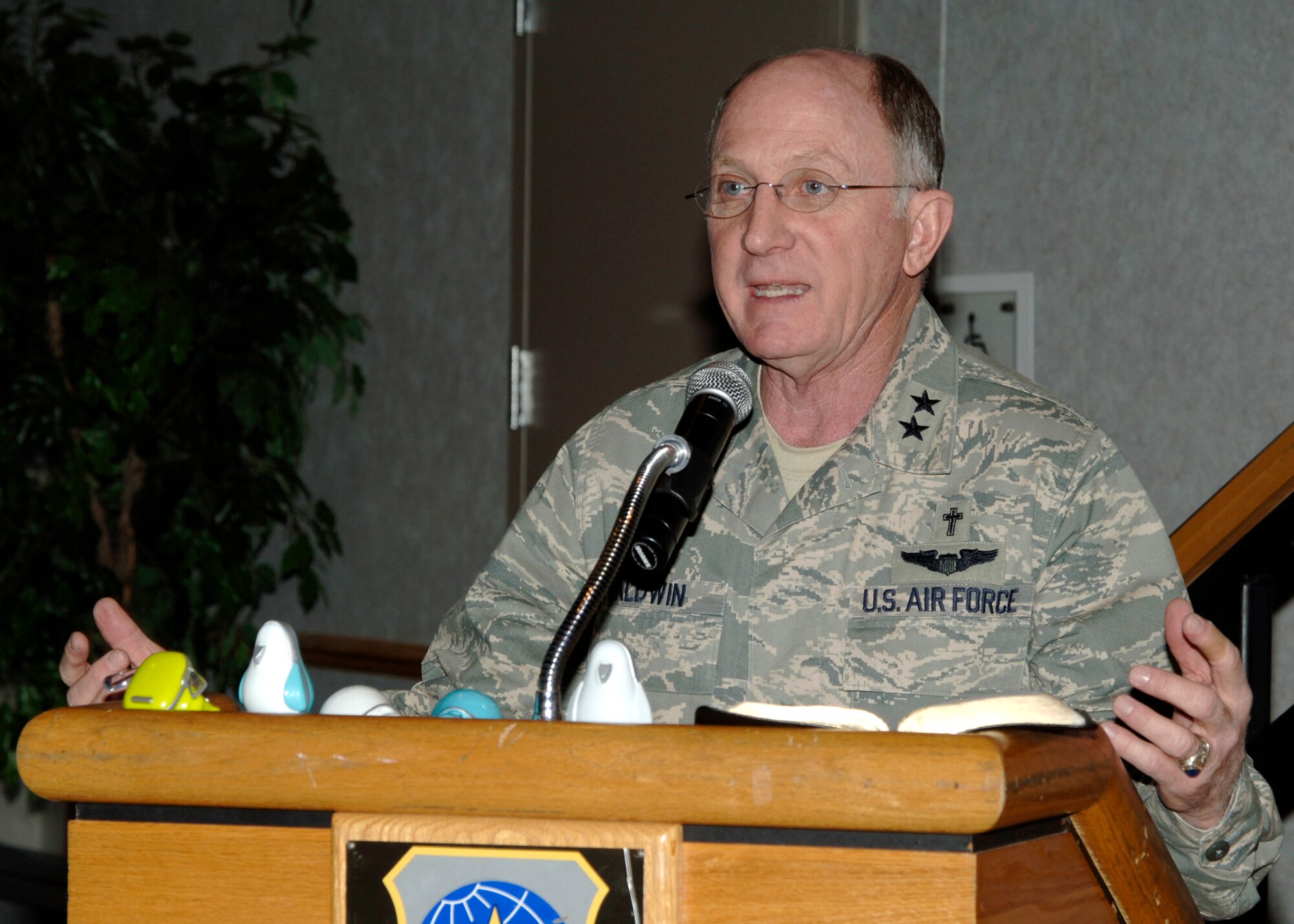 Chaplain (Maj. Gen.) Charles Baldwin, Air Force Chief of Chaplains, gives a speech at the Robert J. Dole Community Center Ballroom, Feb. 21, during a National Prayer Breakfast. In Chaplain Baldwin’s sermon, he references “iGod”, his term inspired by a new wave of technology. He brought along examples of tangible comparisons to relate how God answers needs through prayer. (Photo by Airman Justin Shelton)