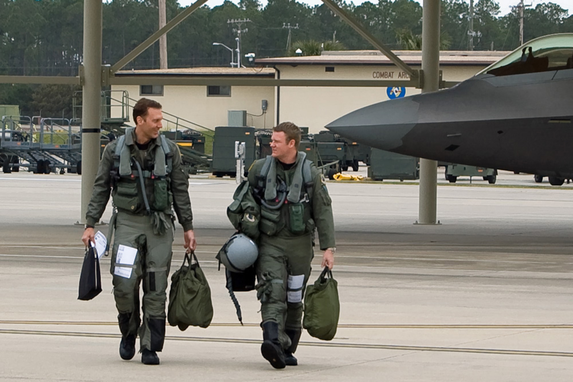 Maj. David Pifferario and Capt. Ryan Pelkola walk to their F-22 Raptors Feb. 4 at Tyndall Air Force Base, Fla. Members of the 3rd Wing and Air Force Reserve Command's 477th Fighter Group from Elmendorf AFB, Alaska, combined for its first F-22 deployment to Tyndall AFB for Combat Archer. The 132 Reserve and active-duty Airmen and eight F-22s from Alaska were in Florida for Weapons System Evaluation Program training. Colonel Shower is the 90th Fighter Squadron commander. Major Pifferario is a 302nd Fighter Squadron F-22 pilot and Captain Pelkola is a 90th Fighter Squadron pilot. (U.S. Air Force photo/Scott Wolfe) 
