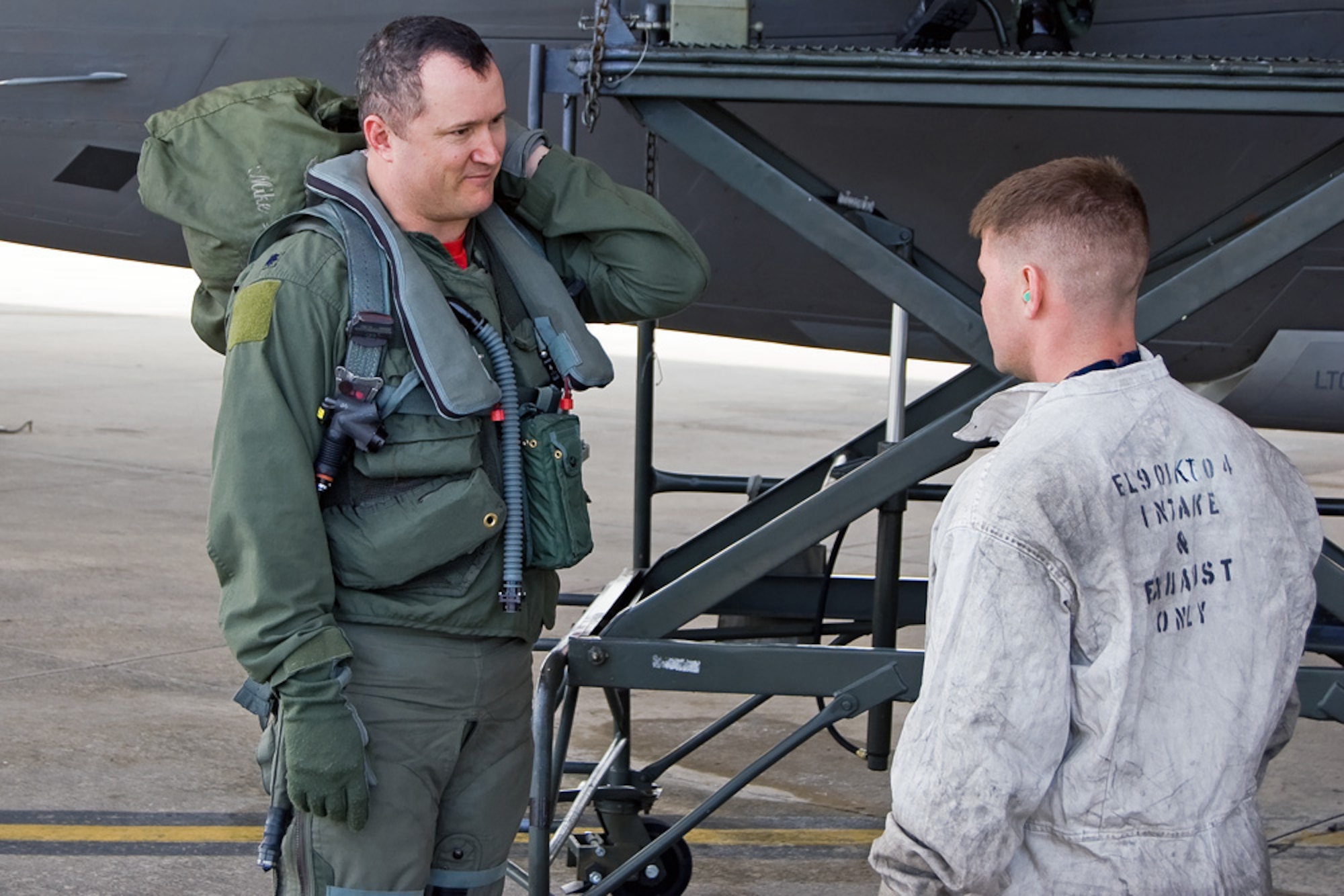Lt. Col. Mike Shower speaks with Staff Sgt. Charlie Grantham after completing a training sortie Feb. 4 at Tyndall Air Force Base, Fla. Members of the 3rd Wing and Air Force Reserve Command's 477th Fighter Group from Elmendorf AFB, Alaska, combined for its first F-22 Raptor deployment to Tyndall AFB for Combat Archer. The 132 Reserve and active-duty Airmen and eight F-22s from Alaska were in Florida for Weapons System Evaluation Program training. Colonel Shower is the 90th Fighter Squadron commander and Sergeant Grantham is assigned to the 90th Aircraft Maintenance Unit. (U.S. Air Force photo/Scott Wolfe) 
