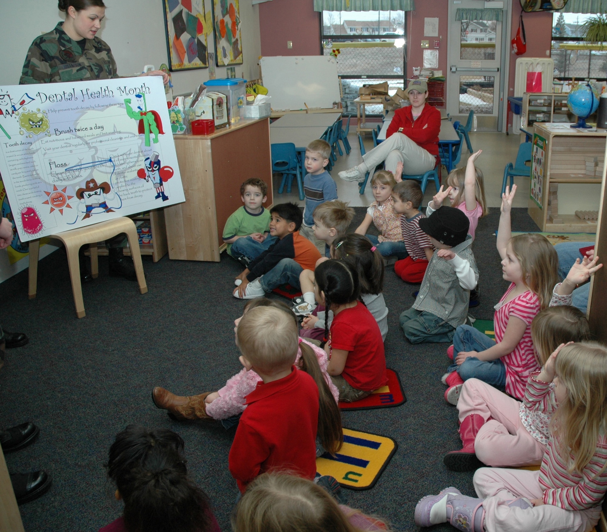 Airman 1st Class Sarah Gustafson from the 341st Medical Operations Squadron dental clinic, explains some key elements of children's dental health to a group of children at the Child Development Center Feb. 12. One of the topics was the importance of not sucking their thumbs. February is National Children's Dental Health Month. (U.S. Air Force photo/Airman 1st Class Emerald Ralston)