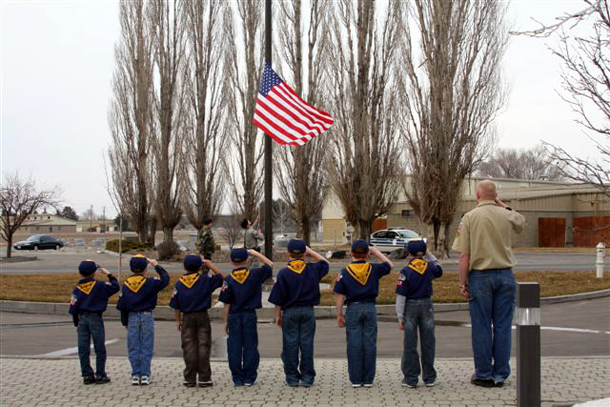 MOUNTAIN HOME AIR FORCE BASE, Idaho - Members of the Mountain Home Air Force Base Cub Scouts, Cub Scout Pack 102, Wolf Den 5, participate in a retreat ceremony Feb. 20 at Building 512 during a visit to the base. The Cub Scout members are (left to right) Dominick Finley, Brandon Stirewalt, John-Jae Banag, Nicolas Horning, Trevor Hill, Ryan Collins, Brock Clifton and Donovan Horning, den leader. (Courtesy photo by Deb Stirewalt)