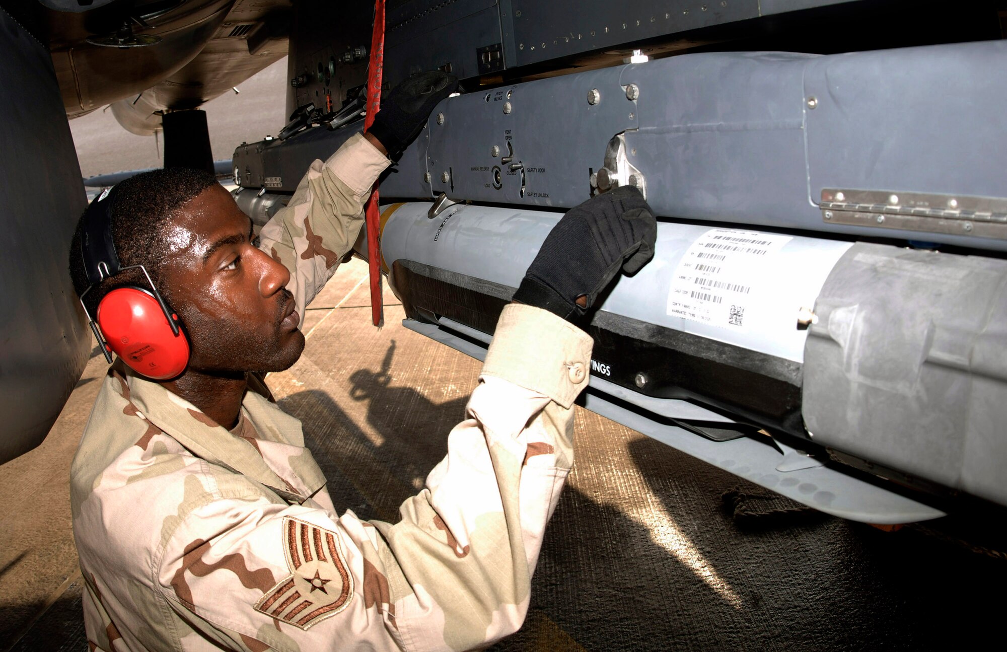 Staff Sgt. Kevin Harvey of the 379th Expeditionary Aircraft Maintenance Squadron secures GBU-39/B small diameter bombs to an F-15E Strike Eagle. The bombs' smaller warheads allow commanders to destroy targets close to friendly troops, civilians, structures and personal property. (U.S. Air Force photo/Senior Airman Ricky Best) 
