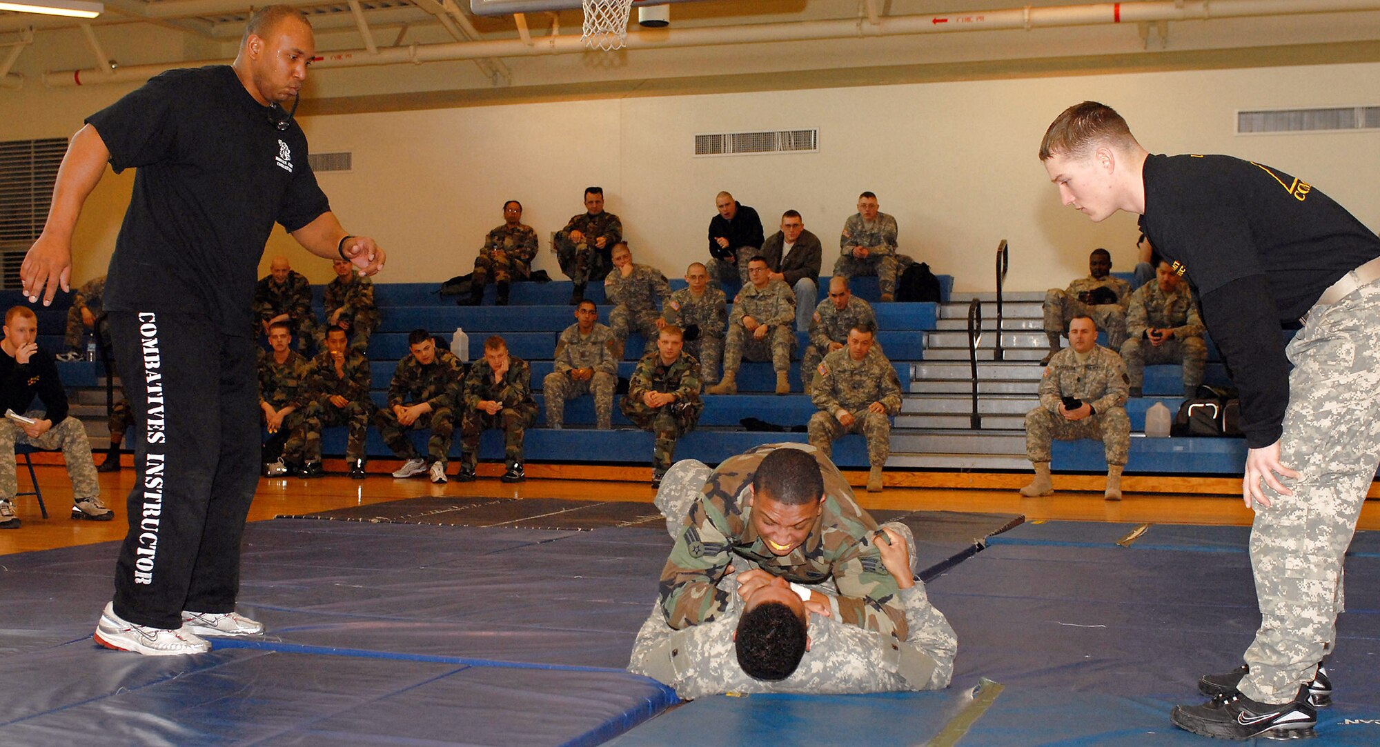 Senior Airman Tesfaya Campbell and Army Pfc. Grayson Damon engage in hand-to-hand combat Feb. 14 at Kunsan Air Base, South Korea. This training is part of the Army warrior ethos. The training is now offered to Airmen here to enhance mission effectiveness between the two services. Air Force officials are currently working on a service specific hand-to-hand combat training for all Airmen. Currently, the Air Force's Officer Training School has implemented a new close-combat course into its curriculum. Airman Campbell is assigned to the 8th Security Forces Squadron and Private Damon is assigned to the 144th Charlie Company Air and Missile Defense unit. (U.S. Air Force photo/Senior Airman Giang Nguyen) 
