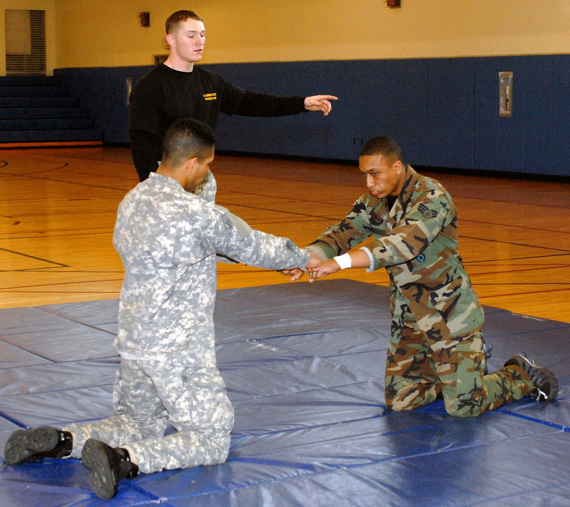 Senior Airman Tesfaya Campbell and Army Pfc. Grayson Damon prepare for hand-to-hand combat Feb. 14 at Kunsan Air Base, South Korea. This training is part of the Army warrior ethos. The training is now offered to Airmen here to enhance mission effectiveness between the two services. Air Force officials are currently working on a service specific hand-to-hand combat training for all Airmen. Currently, the Air Force's Officer Training School has implemented a new close-combat course into its curriculum. Airman Campbell is assigned to the 8th Security Forces Squadron and Private Damon is assigned to the 144th Charlie Company Air and Missile Defense unit. (U.S. Air Force photo/Senior Airman Giang Nguyen) 
