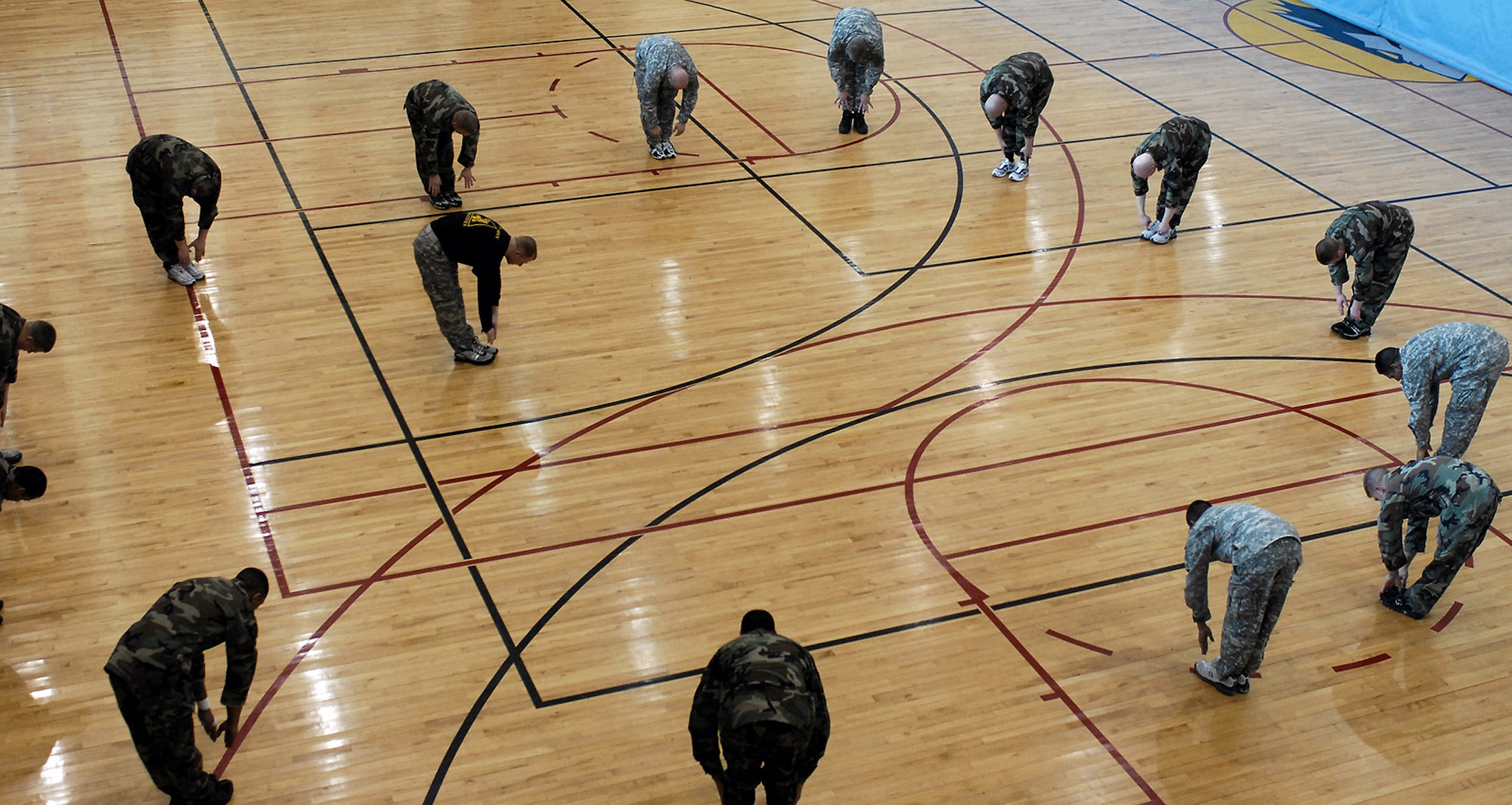 Airmen and Soldiers go through stretching exercises before entering a hand-to-hand combat tournament Feb. 14 at Kunsan Air Base, South Korea. This training is part of the Army warrior ethos. The training is now offered to Airmen here to enhance mission effectiveness between the two services. Air Force officials are currently working on a service specific hand-to-hand combat training for all Airmen. Currently, the Air Force's Officer Training School has implemented a new close-combat course into its curriculum. (U.S. Air Force photo/Senior Airman Giang Nguyen) 