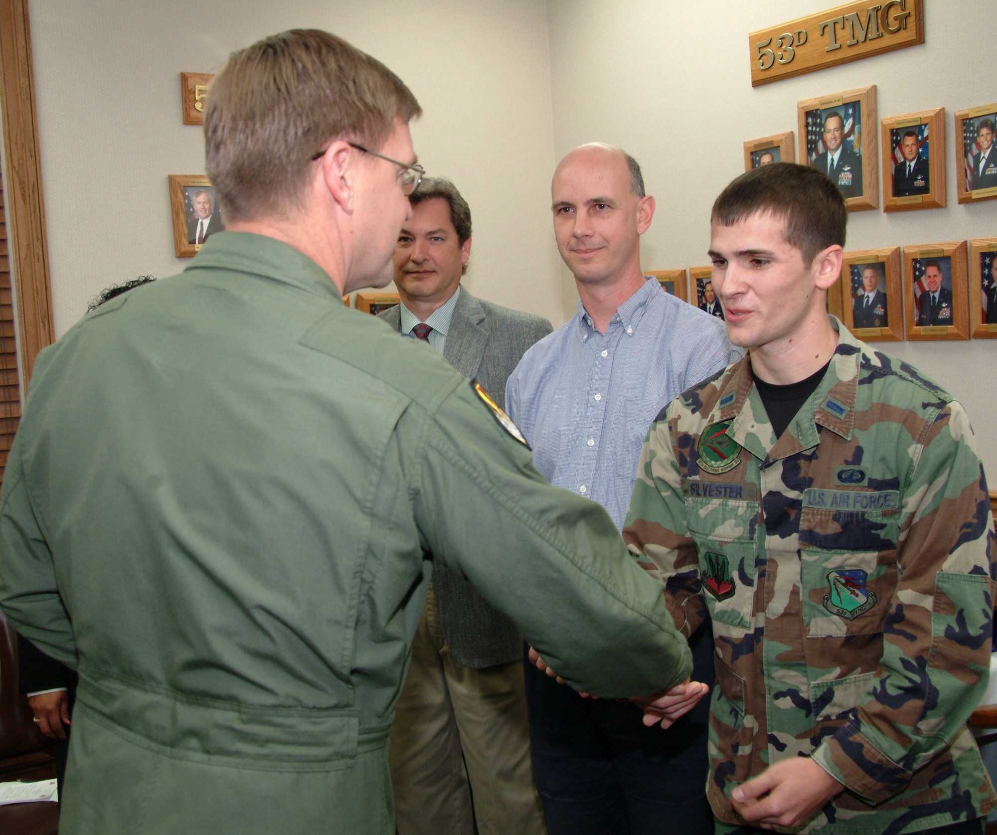 Brig. Gen. Stephen Hoog, United States Air Force Warfare Center commander, presents a coin to 1st Lt. Steven Slyvester, 36th Electronic Warfare Squadron, before the Electronic Warfare Group's briefing during the general's visit with the 53d Wing Feb. 21 at Eglin Air Force Base, Fla.  The lieutenant along with other members of the 36th EWS received coins by the general for winning various engineering awards.  U.S. Air Force photo by Staff Sgt. Samuel King Jr.
