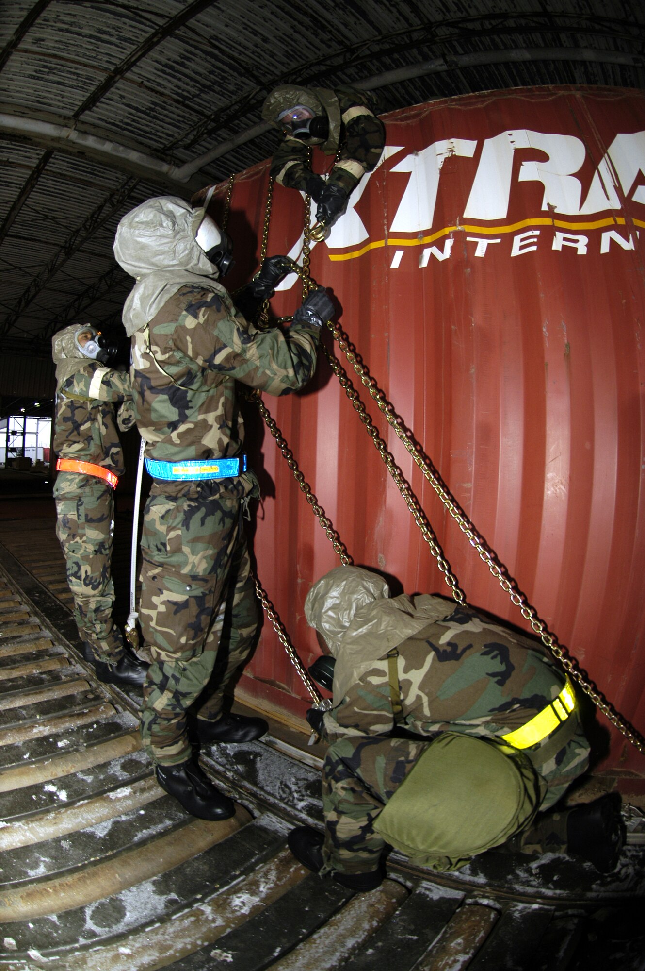 (Left to right) Tech. Sgt. Shon George, 436th Aerial Port Squadron passenger service supervisor; Airman 1st Class Michael Waski, 436th APS fleet services; Senior Airman Matthew Tierney, 436th APS cargo processor specialist; and Airman 1st Class Lance Chafin, 436th APS cargo processor specialist, tie down a storage unit container with chains Feb. 20 during the Ability to Survive and Operate training scenario exercise in preparation for the base’s Operational Readiness Inspection in July. (U.S. Air Force photo/ Airman 1st Class Shen-Chia Chu)