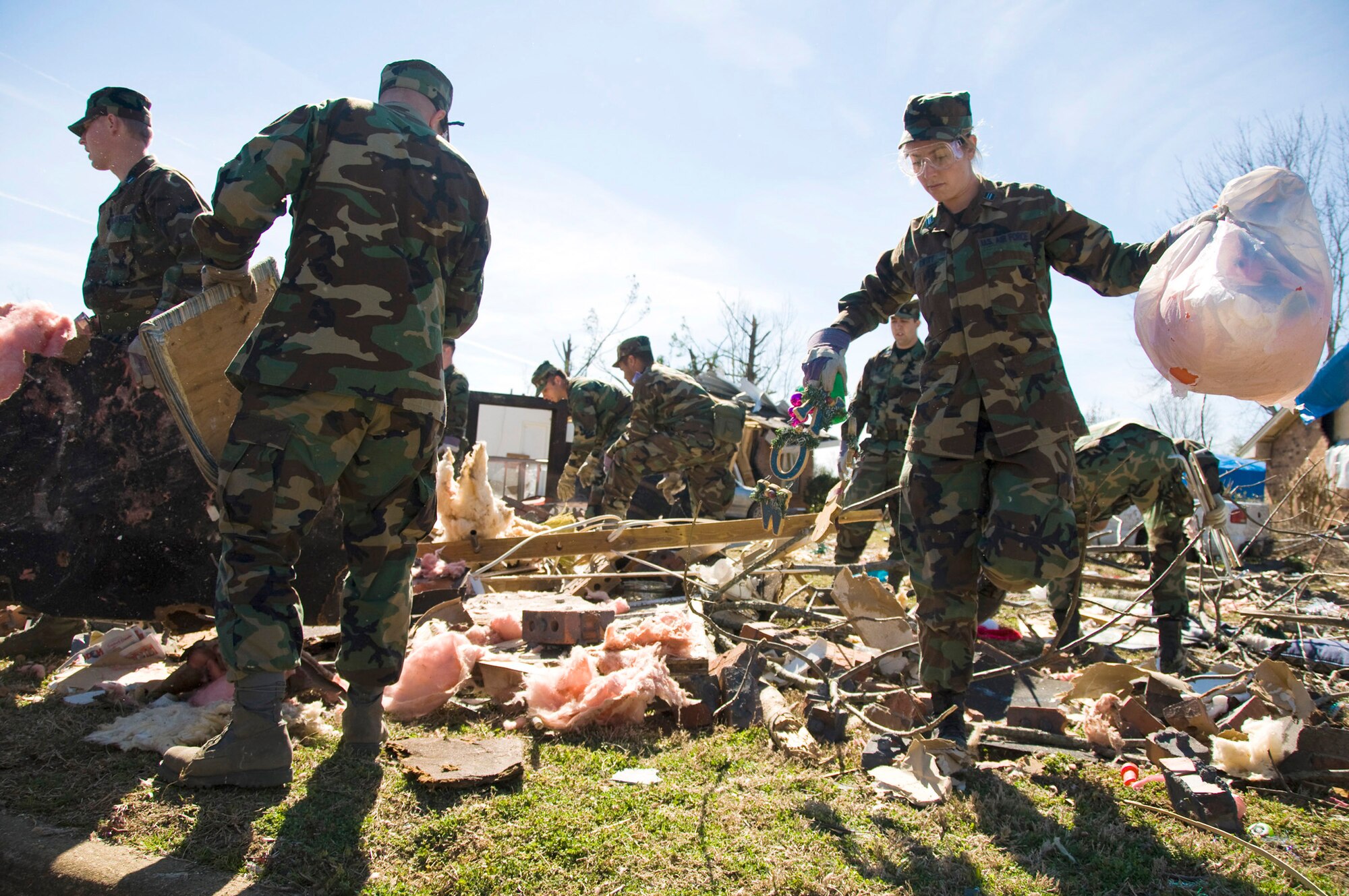 More than 65 Officer Training School basic officer trainees and 20 other Airmen assigned to Maxwell Air Force Base, Ala., clear debris Feb. 19 caused by a Feb. 17 tornado that stormed through Prattville, Ala. The city is located 15 miles northwest of the base. Latest estimates indicate that more than 150 home were destroyed and 760 homes were damaged in a series of storms that created 150 mph winds. Of those homes, approximately 25 military homes were destroyed and 170 were damaged. (U.S. Air Force photo/Master Sgt. Scott Moorman) 
