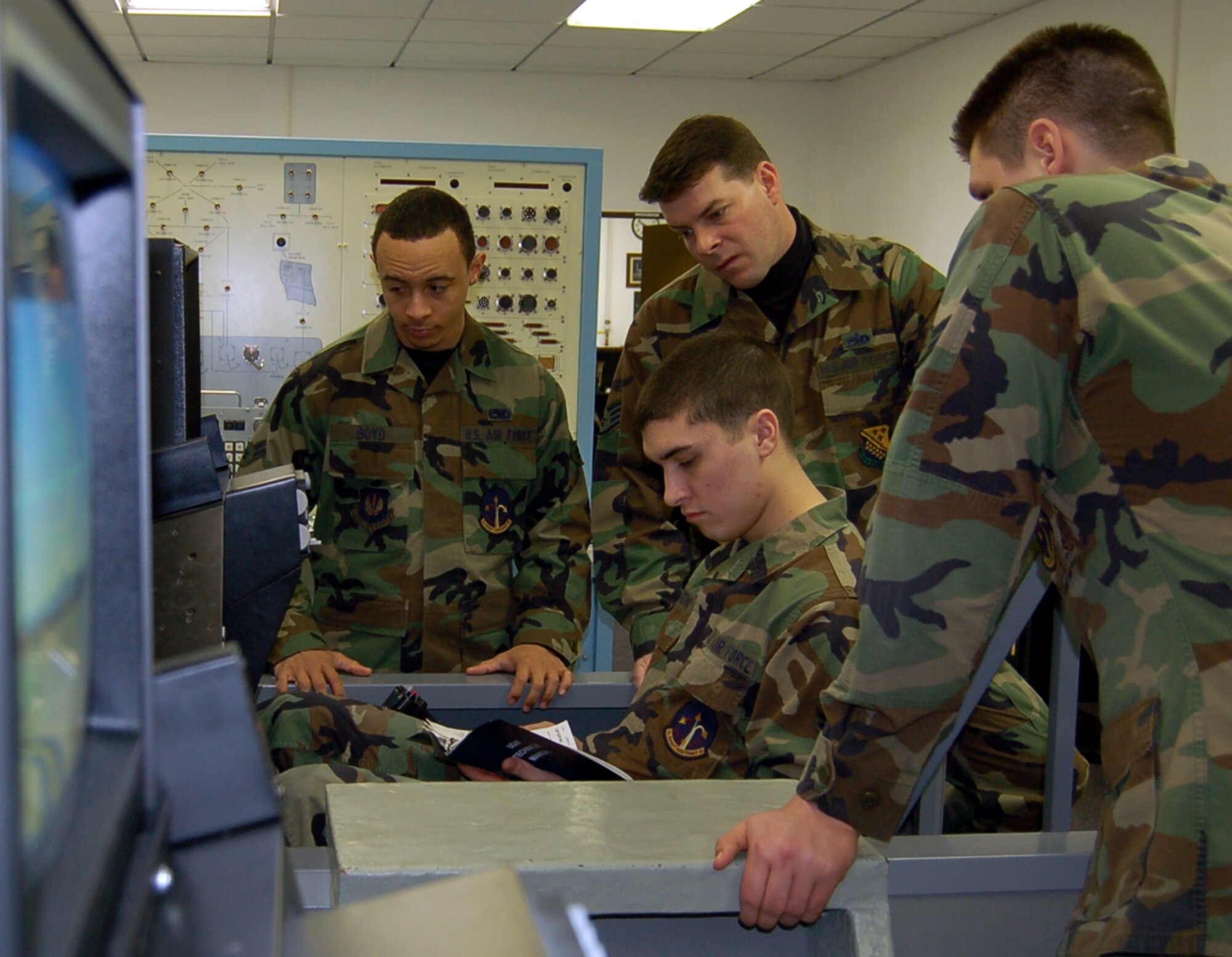 SPANGDAHLEM AIR BASE, Germany – Airman 1st Class John Cardini, 23rd Aircraft Maintenance Unit, references a technical order during a global positioning system training scenario while sitting in an F-16 simulator. Airman Cardini is a student in the 372nd Training Squadron’s F-16 Fire Control Avionics class. (U.S. Air Force photo/Staff Sgt. Tammie Moore)