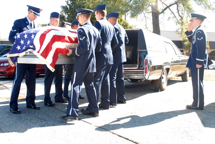Graduating and current Honor Guard members remove a flag-draped casket during a mock burial ceremony as part of their graduation ceremony on Feb. 19. The graduating members participated in the ceremony as part of the requirements to graduate from the Honor Guard Basic Protocol Honors and Ceremony Course. (U.S. Air Force photo/Staff Sgt. Jennifer Arredondo)