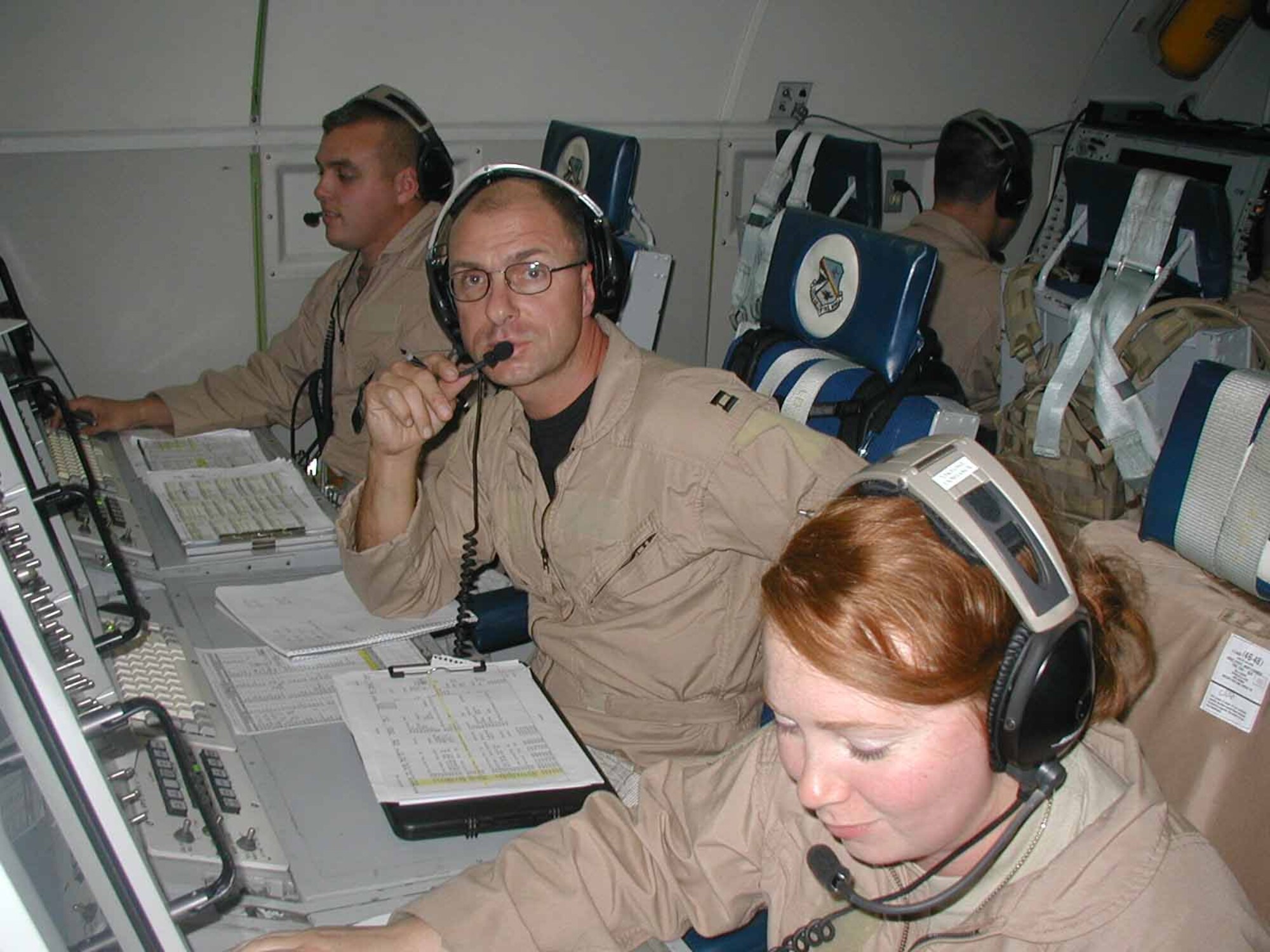 Capt. Darin Lupini, Capt. Clayton Laughlin and Capt. Susan Dunham work hard to provide command and control information while flying an operational mission in support of USCENTCOM.  (Photo courtesy of Airman 1st Class Audrey Page)