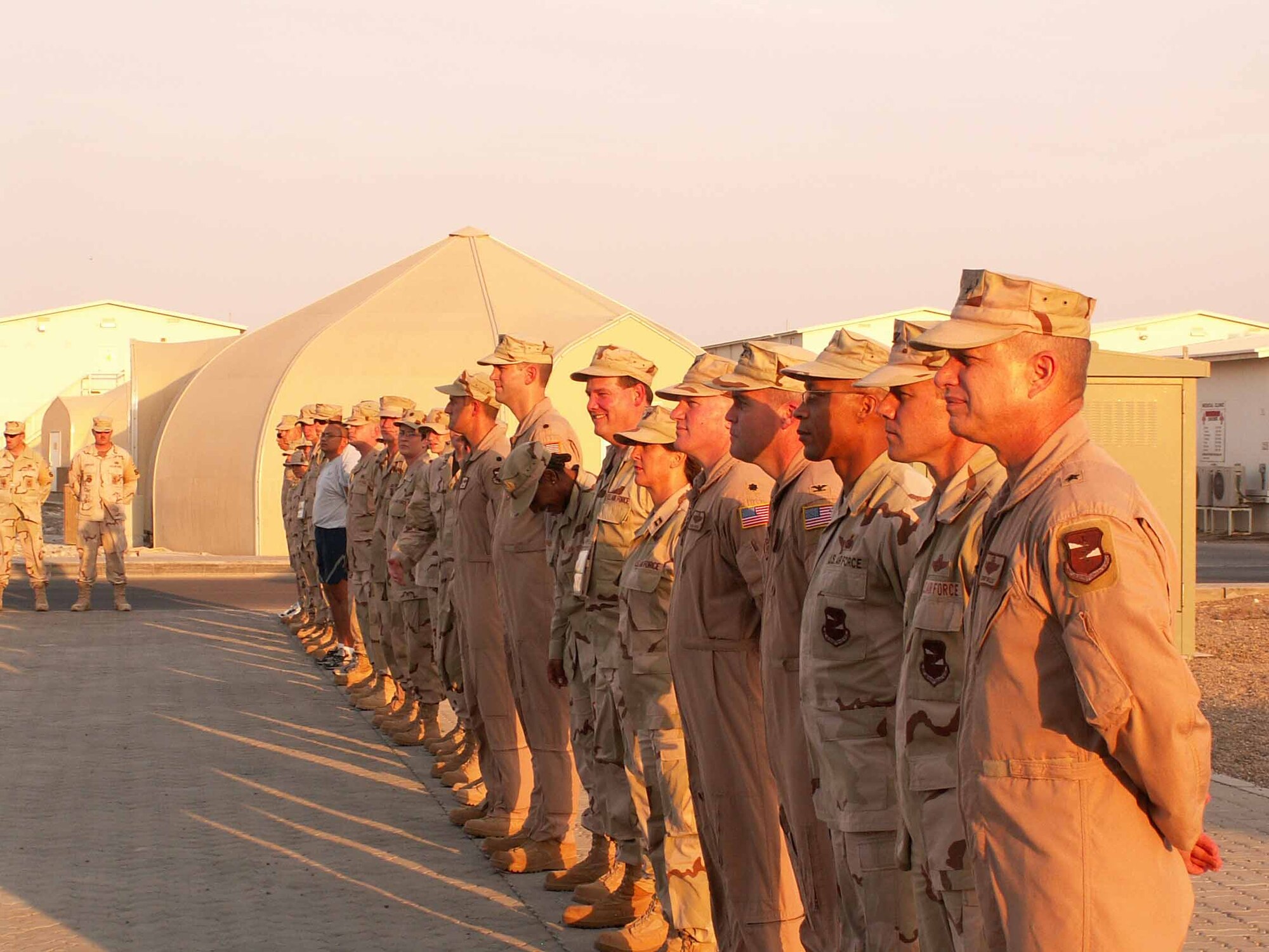 Brig. Gen. Lawrence L. Wells, 380th Air Expeditionary Wing commander, and his command staff line up in formation in the evening sunset.  (Photo courtesy of Master Sgt. Douglas Cataline)