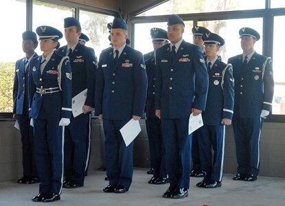 After receiving their certificates, the new members joined the rest of the Honor Guard detail after the graduation ceremony at the 437th Services Squadron headquarters building on Charleston AFB Feb. 19. (U.S. Air Force photo/Staff Sgt. Jennifer Arredondo)

