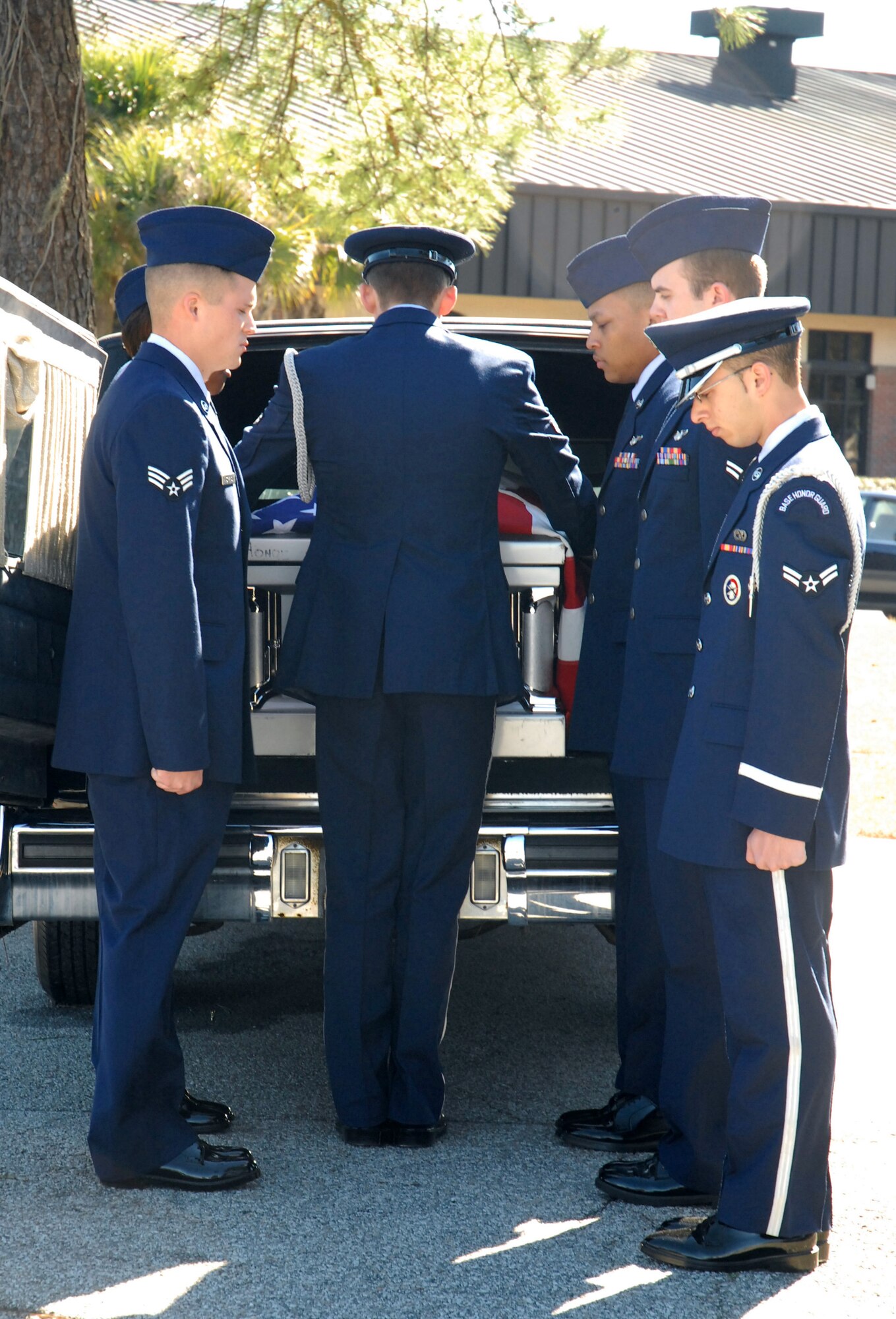 Graduating and current Honor Guard members take a casket from a Hearst during a mock burial ceremony on Charleston AFB Feb. 19.  The graduating members participated in the ceremony as part of the requirements to graduate from the Honor Guard Basic Protocol Honors and Ceremony Course. (U.S. Air Force photo/Staff Sgt. Jennifer Arredondo)