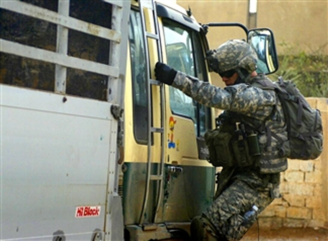 U.S. Army Staff Sgt. William Houdeshell inspects a vehicle for weapons, Feb. 19, 2008, in Aswad, Iraq. Houdeshell, a squad leader, is assigned to the 38th Infantry Regiment's 1st Battalion, Company C.