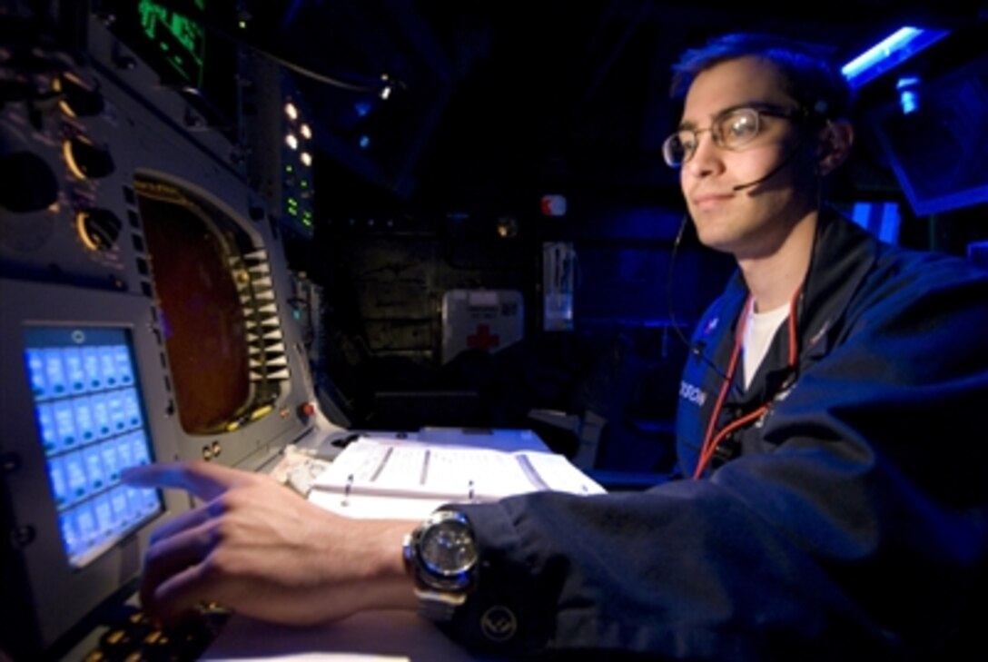 U.S. Navy Petty Officer 2nd Class Andrew Jackson activates a modified tactical Standard Missile-3 from the Combat Information Center of the USS Lake Erie (CG 70) as the ship operates in the Pacific Ocean on Feb. 20, 2008.  The Aegis cruiser launched the missile at a non-functioning National Reconnaissance Office satellite as it traveled in space at more than 17,000 mph over the Pacific Ocean.  The objective was to rupture the satellite’s fuel tank to dissipate the approximately 1,000 pounds (453 kg) of hydrazine, a hazardous material which could pose a danger to people on earth, before it entered into earth's atmosphere.   USS Decatur (DDG 73) and USS Russell (DDG 59) were also part of the task force.  