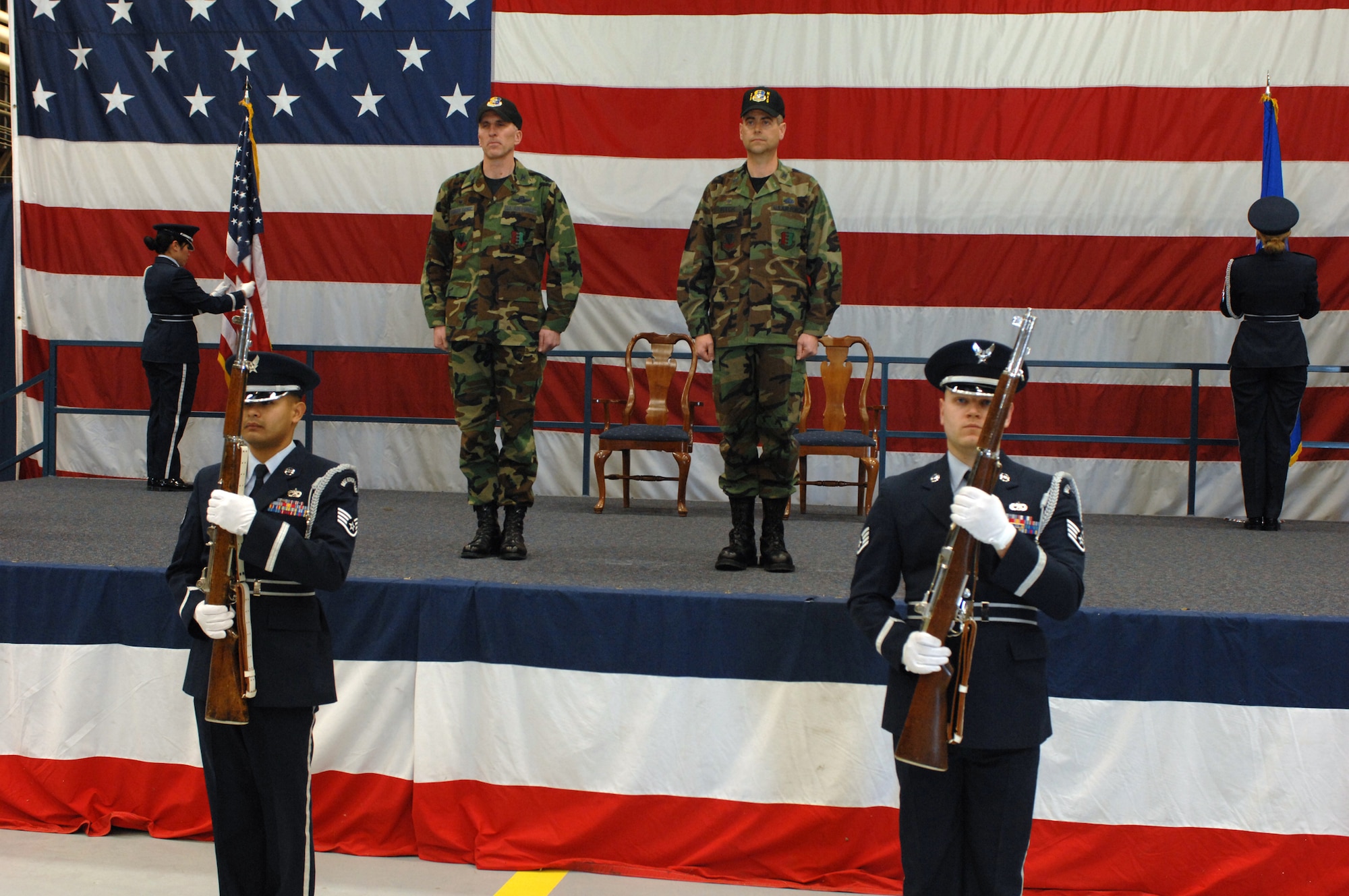 Col. Scott Vander Hamm, 28th Bomb Wing commander and Col. and Thomas Fitch, 28th Maintenance Group commander are accompanied by the 28th Bomb Wing Honor Guard Feb. 22 during Col. Fitch's assumption of command of the 28th Maintenance Group.  1st Lt. MaryAnne Nguyen, 2nd Lt. Elizabeth Cramer, Staff Sgt. Ruben TrejoSanchez, and Staff Sgt. Aaron Smith post the colors during assumption of command. (U.S. photo/Airman 1st Class Adam Grant)