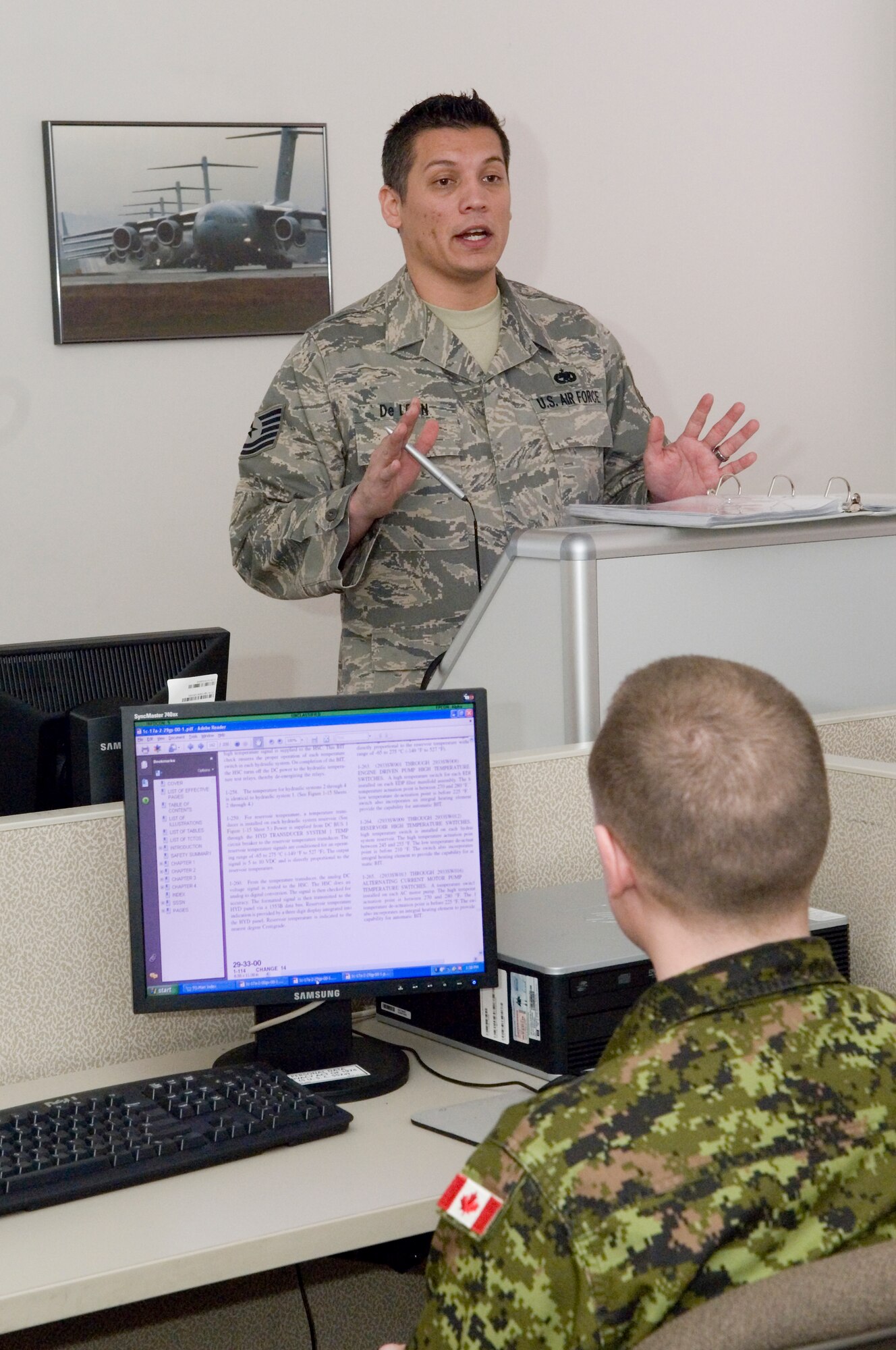 Tech. Sgt. Ed Deleon, 373rd Training Squadron, Detachment 12, lectures Canadian air force maintainers on the C-17 Globemaster III's secondary flight controls during a recent hydraulics class.