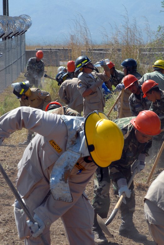 Honduran military and civilian firefighters dig a fire break at Soto Cano Air Base, Honduras. The firefighters are participating in a JTF-Bravo-sponsored firefighting subject matter expert exchange. During the exchange, a learning exposition for U.S. and Honduran firefighters, a great level of importance is placed on land navigation and fighting wildfires. (U.S. Air Force photo by Tech. Sgt William Farrow)