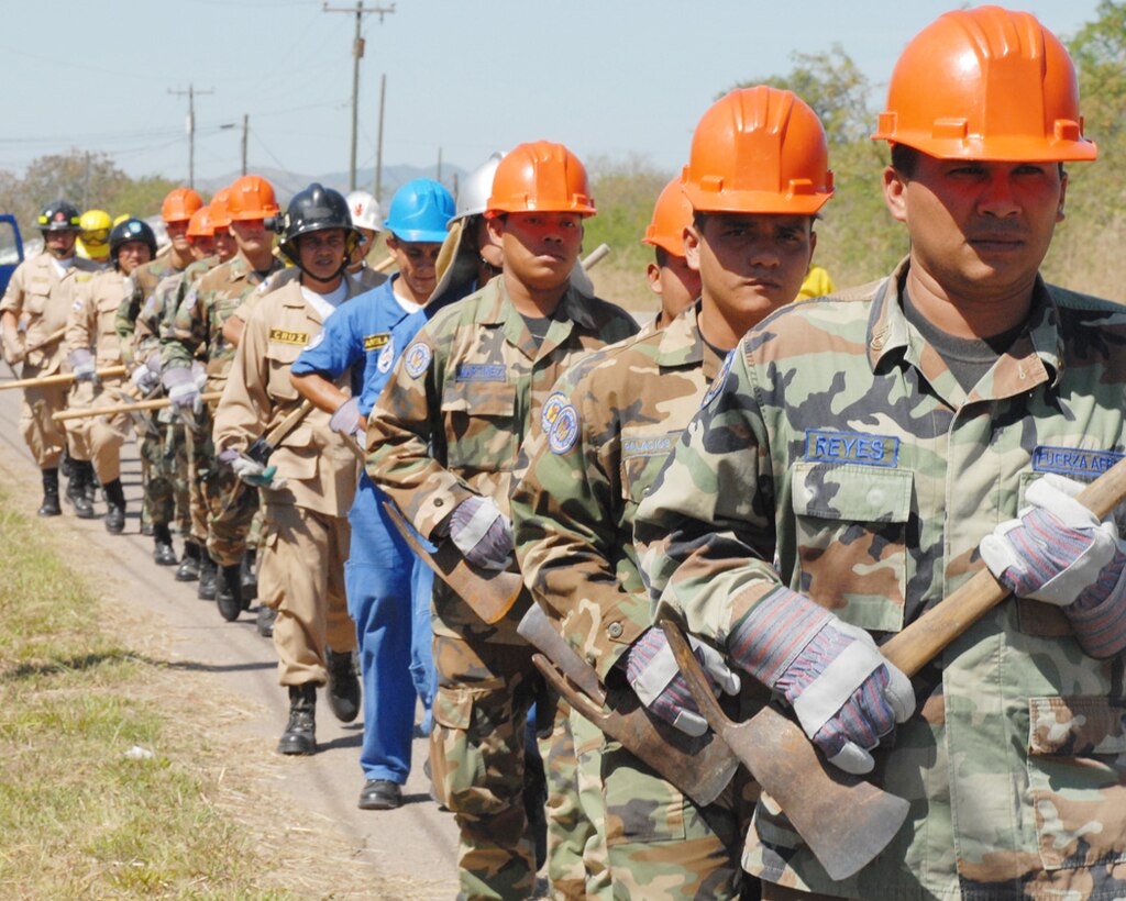 Honduran military and civilian firefighters march toward an area of Soto Cano Air Base to dig a fire break (a gap in vegetation or other combustible material that is expected to slow or stop the progress of a wildfire). The firefighters participated in a JTF-Bravo-sponsored firefighting subject matter expert exchange, a learning exposition for firefighters.  During the exchange, a great level of importance is placed on land navigation and fighting wildfires. (U.S. Air Force photo by Tech. Sgt William Farrow)
