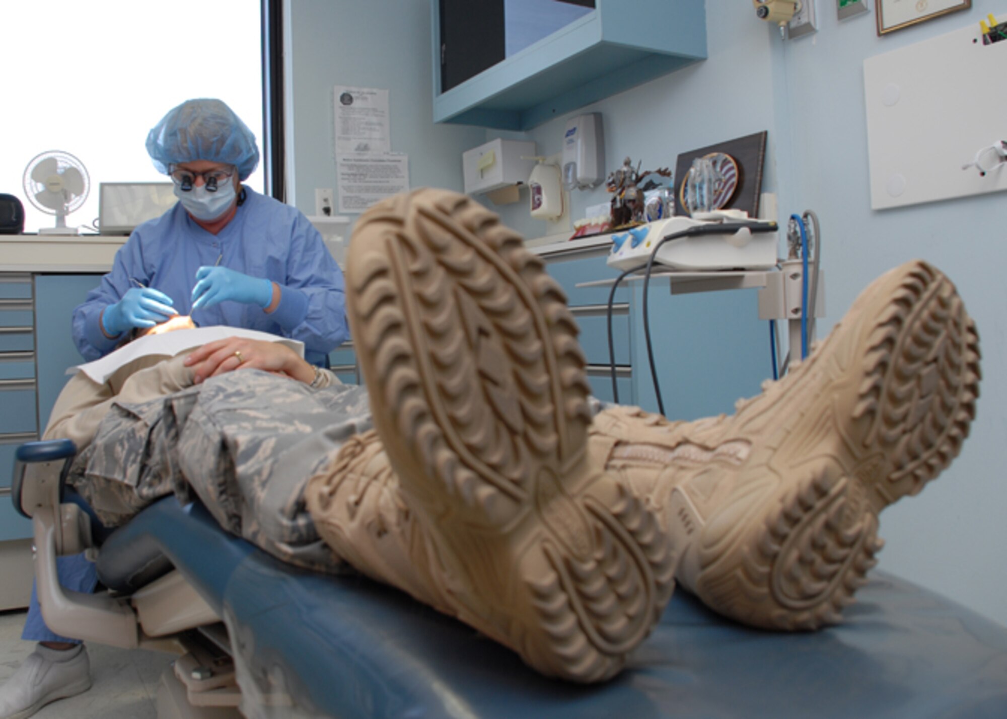 EGLIN AIR FORCE BASE, Fla. -- Jo Lowery, 96th Dental Squadron hygienist, works on a patient inside the dental clinic. Mrs. Lowrey was recently Civilain of the Year, category III for her dedication and professionalism on and off duty. Throughout the year, she performed more than 1,000 cleanings, out producing the next dental technician by 54 percent. Among her many accomplishments, she learned sign language to communicate with a co-worker, improving clinic relations. (U.S. Air Force photo by Staff Sgt. Mike Meares)