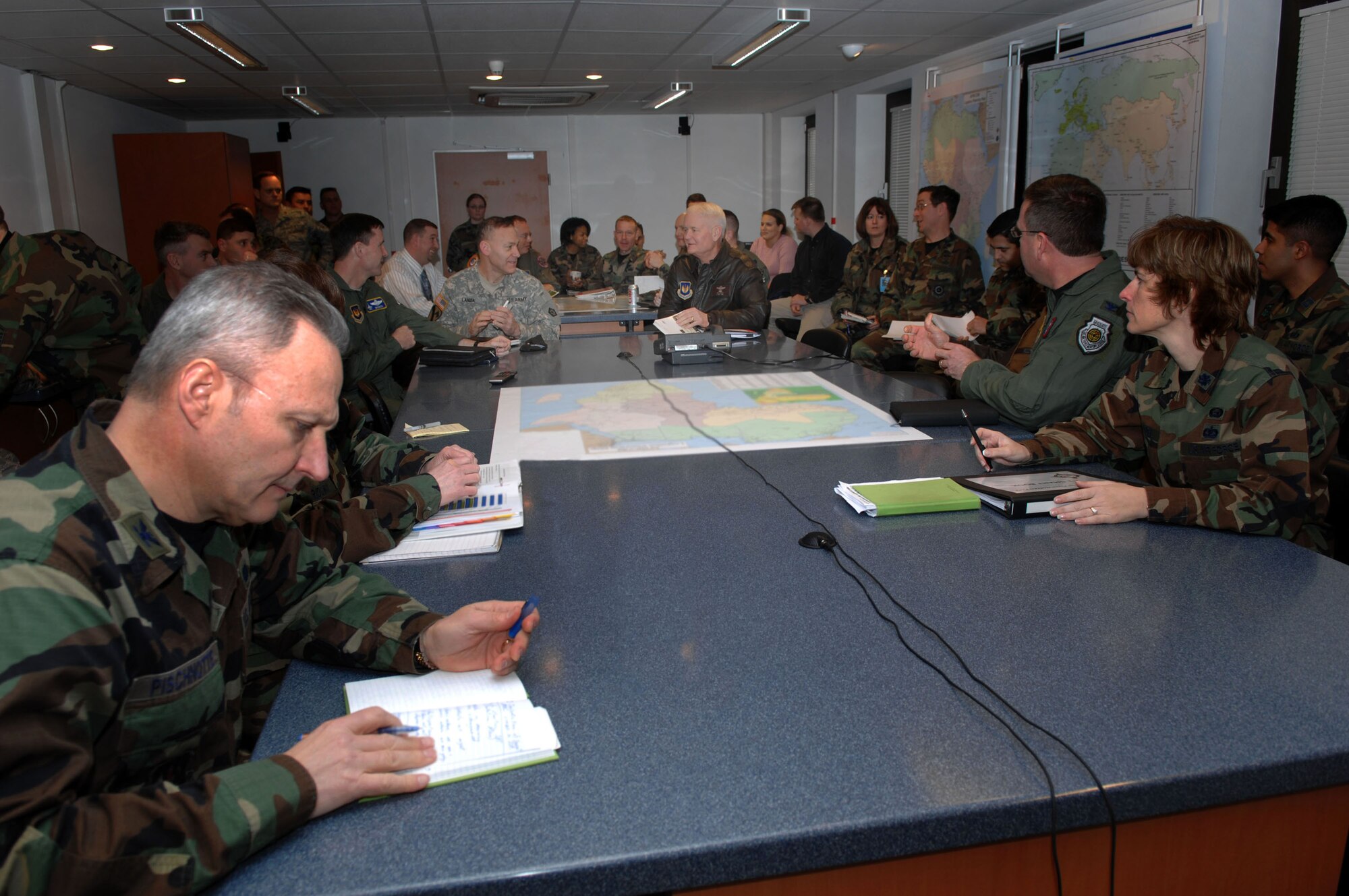 Lt. Gen. Rod Bishop (center right) and Army Brig. Gen Steve Lanza (center left), Joint Task Force-Nomad Fire commander and deputy commander respectively, receive an update briefing on the daily operations of the activities associated with President George W. Bush's five-nation visit to Africa.  JTF-NF was established to provide support to various functions including Air Force One as well as to provide aeromedical support, command and control support and helicopter support in Liberia.  (U.S. Air Force photo/Senior Master Sgt. Hollis Dawson)