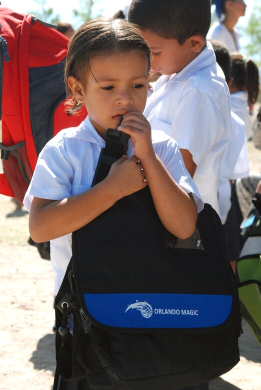 A girl at the Carlos Sanchez school in La Paz, Honduras, holds a backpack packed with school supplies given to her by troops from Soto Cano Air Base. Five representatives from the Give a Kid a Backpack organization in Florida and 15 volunteers from JTF-Bravo distributed more than 700 backpacks packed with school supplies to children at five schools and two orphanages in the Comayagua and La Paz districts. (U.S. Air Force photo by Tech. Sgt John Asselin)
