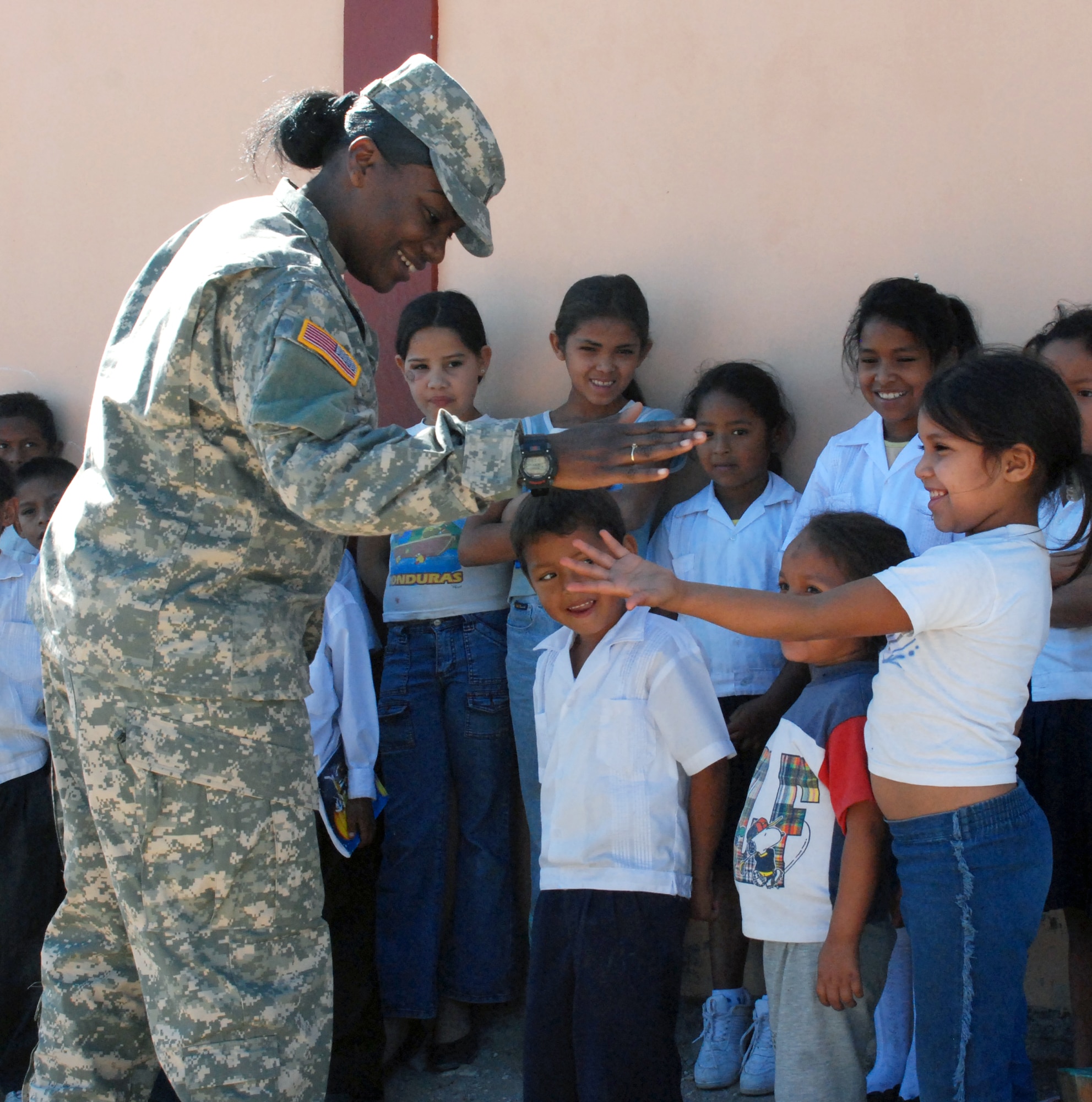 Army Staff Sgt. Tracey Francis, team medic for JTF-Bravo Civil Military Operations, plays with children at Carlos Sanchez School in La Paz, Honduras, Feb. 21. The children later received backpacks packed with school supplies donated by children in the United States. (U.S. Air Force photo by Tech. Sgt John Asselin)
