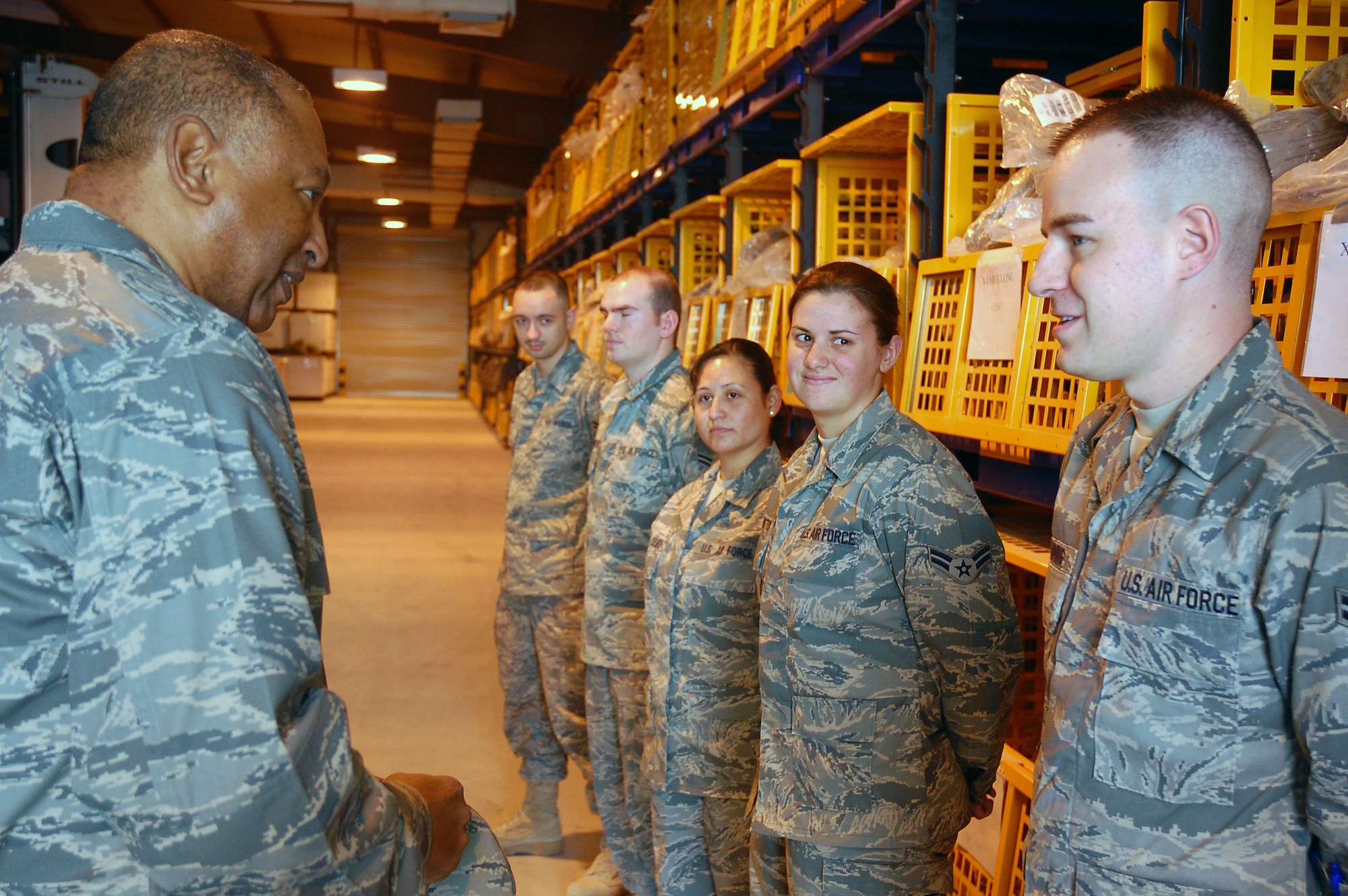 Maj. Gen. Gary T. McCoy, director of logistics readiness for the office of the deputy chief of staff for logistics, talks with Airmen at the expeditionary theater distribution center during his visit to an air base in Southwest Asia.  The general's visit was the last stop on a tour of five bases in the Central Command area of operations. (U.S. Air Force photo/Capt. Jason McCree)