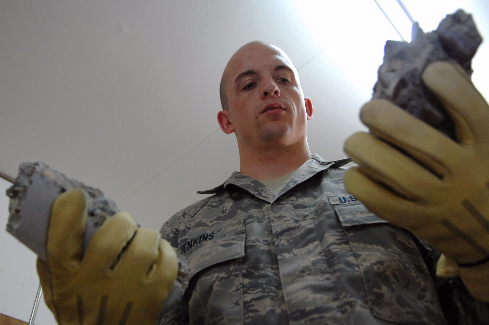 Staff Sgt. Jack Jenkins examines the broken pieces of a concrete cylinder sample taken from the new Housing 6 area shoppette foundation Feb. 21 at Balad Air Base, Iraq. These tests confirm aircraft or buildings can be put on concrete surfaces without the concrete cracking or sinking. Sergeant Jenkins is a 332nd Civil Engineer Squadron engineering assistant deployed from Ellsworth Air Force Base, S.D. (U.S. Air Force photo/Senior Airman Julianne Showalter) 
