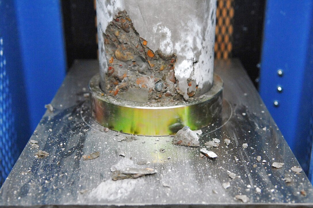 A concrete cylinder sample taken from the new Housing 6 area shoppette foundation broke during the strength test at 5,100 pounds per square inch, which is a passing number Feb. 21 at Balad Air Base, Iraq. These tests confirm aircraft or buildings can be put on concrete surfaces without the concrete cracking or sinking. The minimum number to pass is 4,500 pounds per square inch. (U.S. Air Force photo/Senior Airman Julianne Showalter) 
