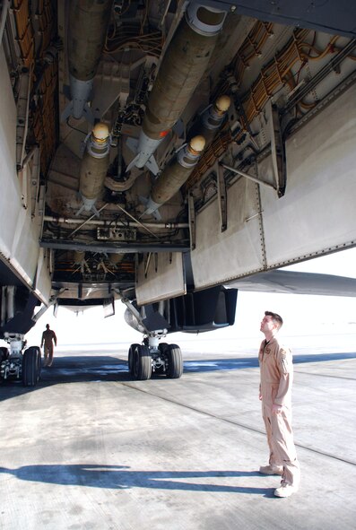 First Lt. Jason Edwards checks the bomb load of a B-1B Lancer as he and the rest of the aircrew preflight check the bomber prior to a mission. Lieutenant Edwards is with the 9th Expeditionary Bomb Squadron at an air base in Southwest Asia. (U. S. Air Force photo/Staff Sgt. Douglas Olsen)