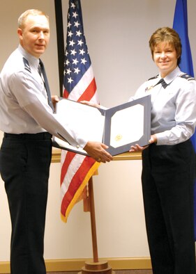 Col. Mike Brice (left), 367th Recruiting Group comander, receives the Outstanding Unit Award from Brig. Gen. Suzanne Vautrinot, Air Force Recruiting Service commander. U. S. Air Force photo by Kendahl Johnson