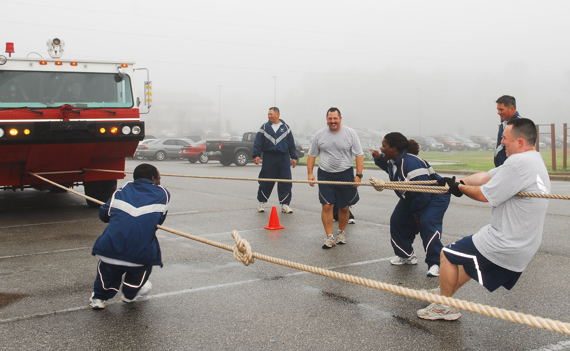 One of the teams from the 1st Special Operations Services Squadron pulls as hard as they can during the Firetruck Pull Feb. 22 behind the Aderholt Fitness Center. The 1st SOSVS won the event with a time of 31 seconds. The Firetruck Pull, which required teams to move the 28,000 pound truck, was one of this year's Commander's Cup challenges. (U.S. Air Force photo/Airman 1st Class Sheila DeVera)