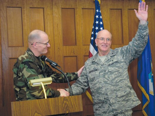 Col. Paul Ackerley, 316th Wing commander, shakes the hand of Ch. (Brig. Gen.) Cecil R. Richardson, Air Force Deputy Chief of Chaplains, the guest speaker at the National Prayer Luncheon at Andrews Air Force Base, Md., on Feb 15. The luncheon included readings from Hebrew, Islamic and Christian scriptures and a speech from Chaplain Richardson entitled "In God We Trust".  (US Air Force/SrA Renae Kleckner)