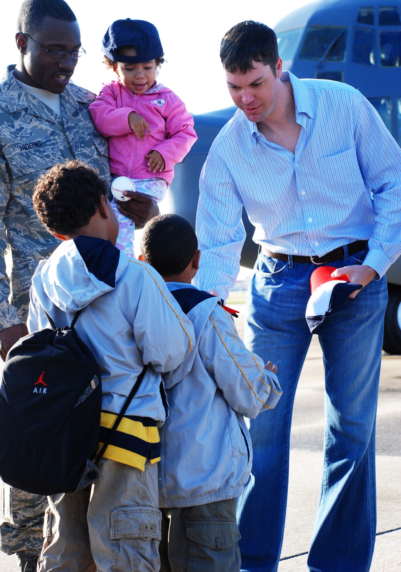 PATRICK AIR FORCE BASE, Fla. -- John Patterson, a pitcher for Major League Baseball's Washington Nationals, hands out hats to children of deploying Air Force reservists at Patrick Air Force Base, Fla., Feb. 20. The Nationals play their spring-training games at nearby Space Coast Stadium. (U.S. Air Force photo/Staff Sgt. Paul Flipse)