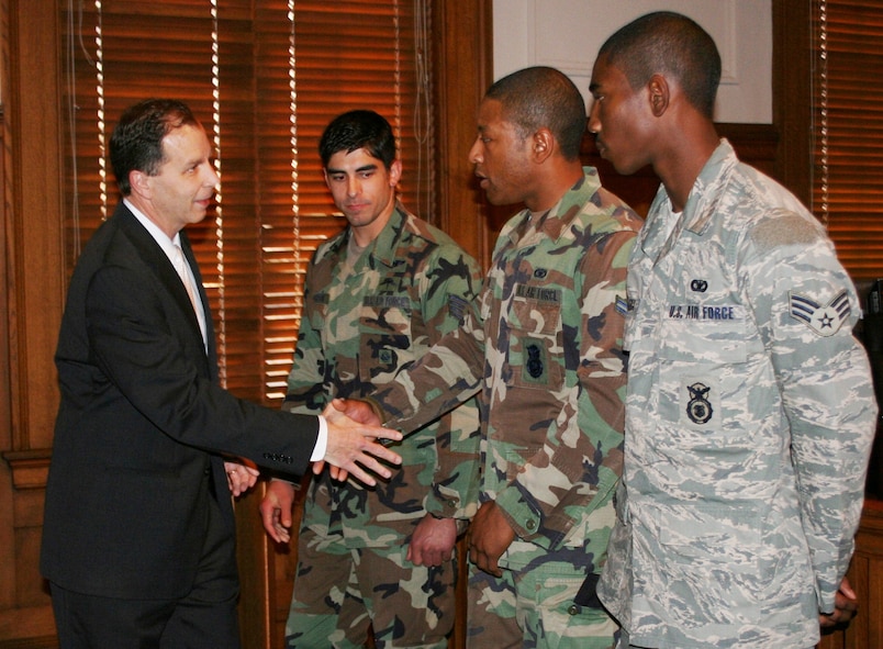 VALDOSTA, Ga. -- Valdosta Mayor John Fretti shakes hands with Airman First Class Rodney Bryant, 23rd Security Forces Sqadron, during the mayor's "State of the City" address at the City Council Chamber here Feb. 7. During his address, the mayor recognized Airman Bryant, as well as Staff Sgt. Mark-Daniel Houghton, 38th Rescue Squadron, and Senior Airman Emanuel Withers, 822nd Security Forces Squadron, for their service during Operations Iraqi and Enduring Freedom.  (Courtesy photo)