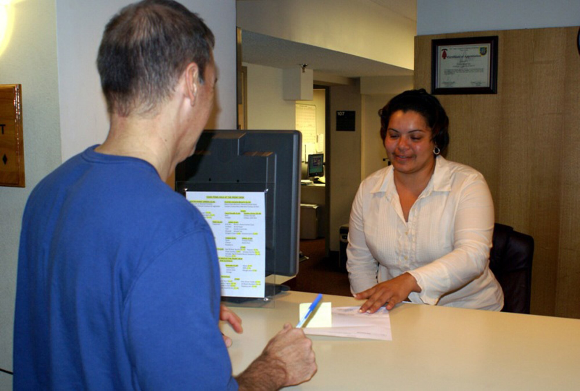 Yisenia Ramos, Homestead Inn front desk receptionist, checks a guest out of base lodging on Feb. 22. Large-scale renovation projects are underway at Homestead Inn that include a new $6.9 million, 37-room addition. In addition, improvements such as replacing drywall, painting, and furniture and carpet replacement are planned for all existing buildings. (U.S. Air Force photo)