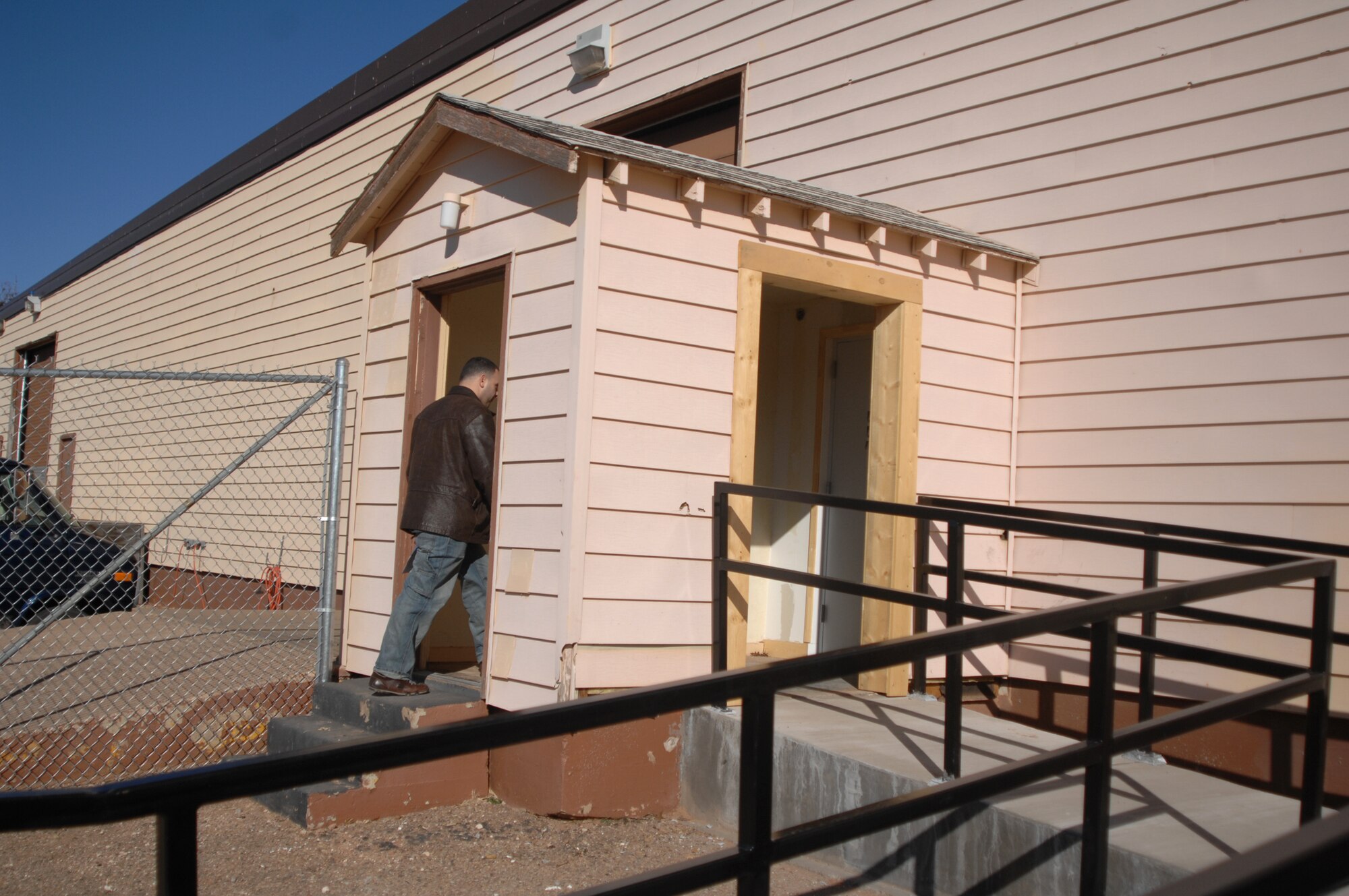 CANNON AIR FORCE BASE, N.M. -- A customer makes his way to the relocated base post office, now at W St, near Outdoor Services and Recreation. The old post office building was demolished to make way for new base facilities. According to Postmaster Aziza Matthias, the base post office  will be located here for at least the next two years. Its hours of operation are Monday through Friday, 8 a.m. to 5 p.m. It is closed 2:45-3:45 p.m. for lunch. (Air Force photo by Greg Allen)