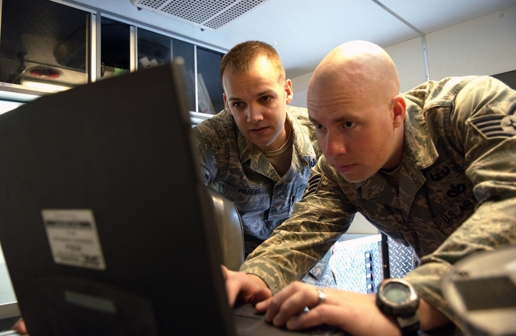 EIELSON AIR FORCE BASE, Alaska -- Staff Sgt. Christopher Adams and Senior Airman Steven Harris analyze X-ray results of a suspected improvised explosive device checking the explosive power it contains on Feb. 21, in Fairbanks. The 354th Civil Engineer Squadron Explosive Ordnance Disposal flight responded to a call from a state trooper that confiscated a suspected IED and ammunition from a local in Fairbanks. Eielson EOD is the only unit in central Alaska with explosive ordnance disposal capabilities. (U.S. Air Force Photo/Airman 1st Class Jonathan Snyder)