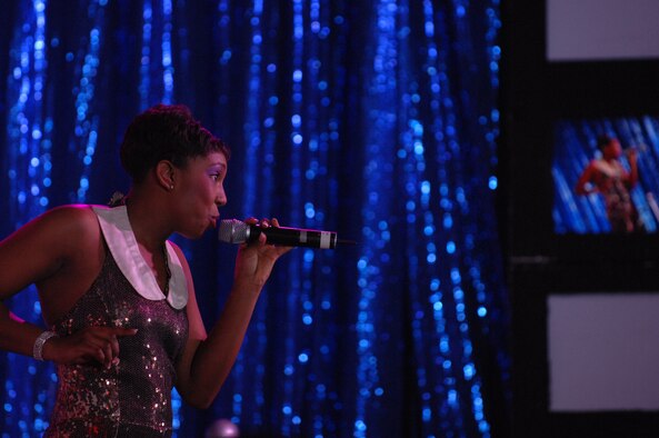 BARKSDALE AIR FORCE BASE, La.- Senior Airman Chonte Walker, 2d Civil Engineer Squadron, sings during a Tops in Blue show held at Hoban Hall here on Feb 7. This was Airman Walker's homecoming performance; she is stationed at Barksdale and will return at the end of the tour. (U.S. Air Force photo by Airman 1st Class Joanna M. Kresge)
