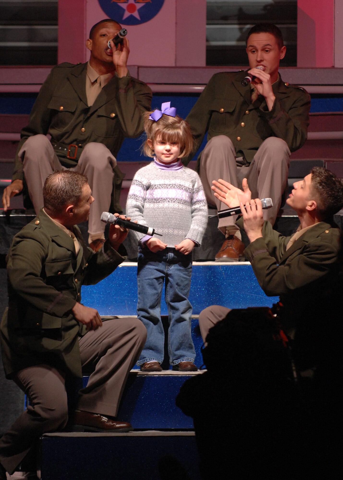 BARKSDALE AIR FORCE BASE, La.- Members of the Tops in Blue sing to the daughter of a Barksdale officer during a Tops in Blue concert held at Hoban Hall here on Feb. 7. (U.S. Air Force photo by Airman 1st Class Joanna M. Kresge)