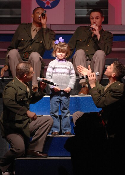BARKSDALE AIR FORCE BASE, La.- Members of the Tops in Blue sing to the daughter of a Barksdale officer during a Tops in Blue concert held at Hoban Hall here on Feb. 7. (U.S. Air Force photo by Airman 1st Class Joanna M. Kresge)