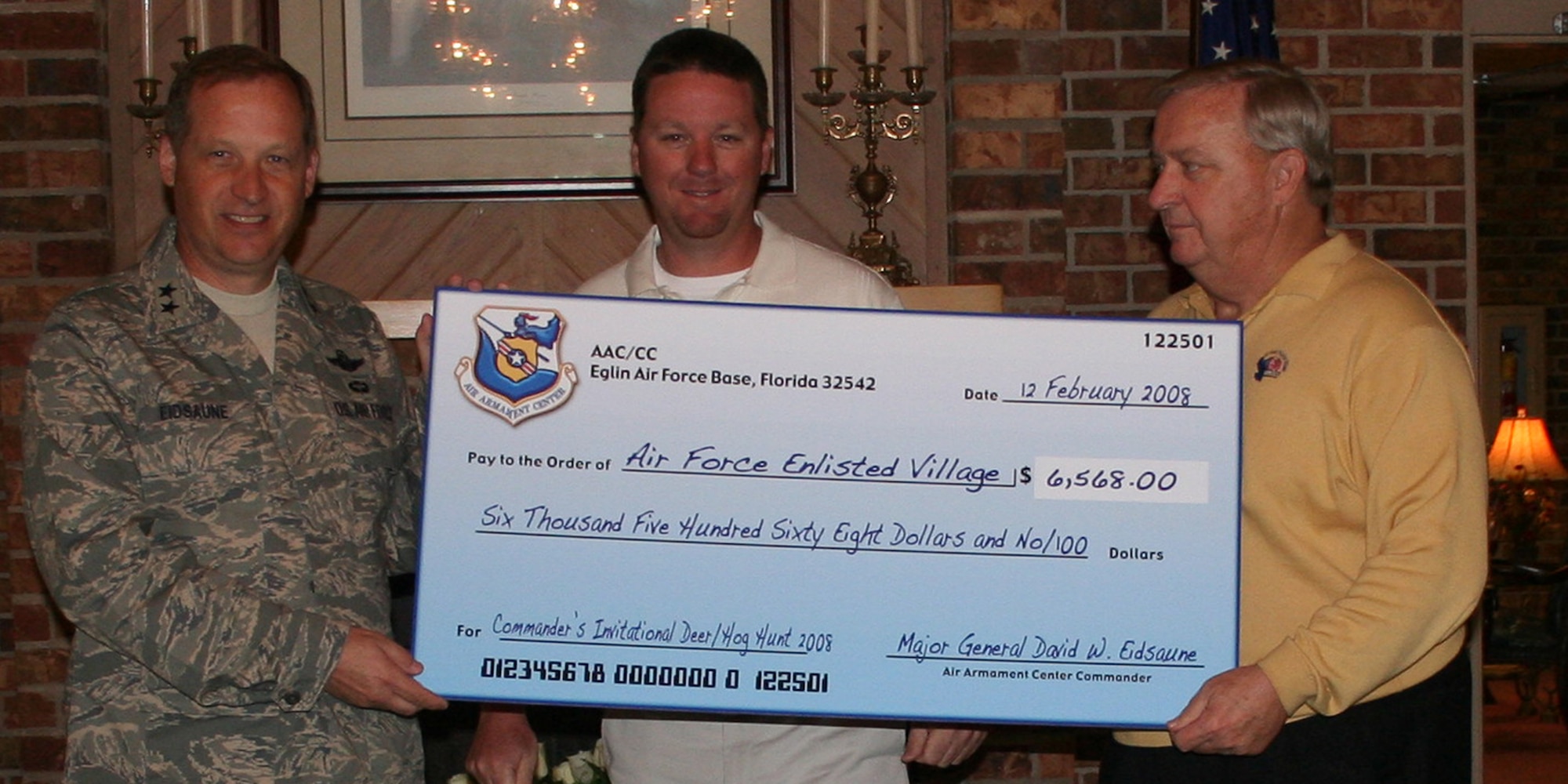 Maj. Gen. David Eidsaune, Program Executive Officer for Weapons and Air Armament Center Commander, Justin Johnson, Eglin Air Force Base Natural Resources Branch; and Jim Binnicker, Air Force Enlisted Village president and CEO, pose with a check for $6,568 presented to the AFEV from proceeds raised during the 2008 Commander?s Hunt at Eglin Air Force Base. 