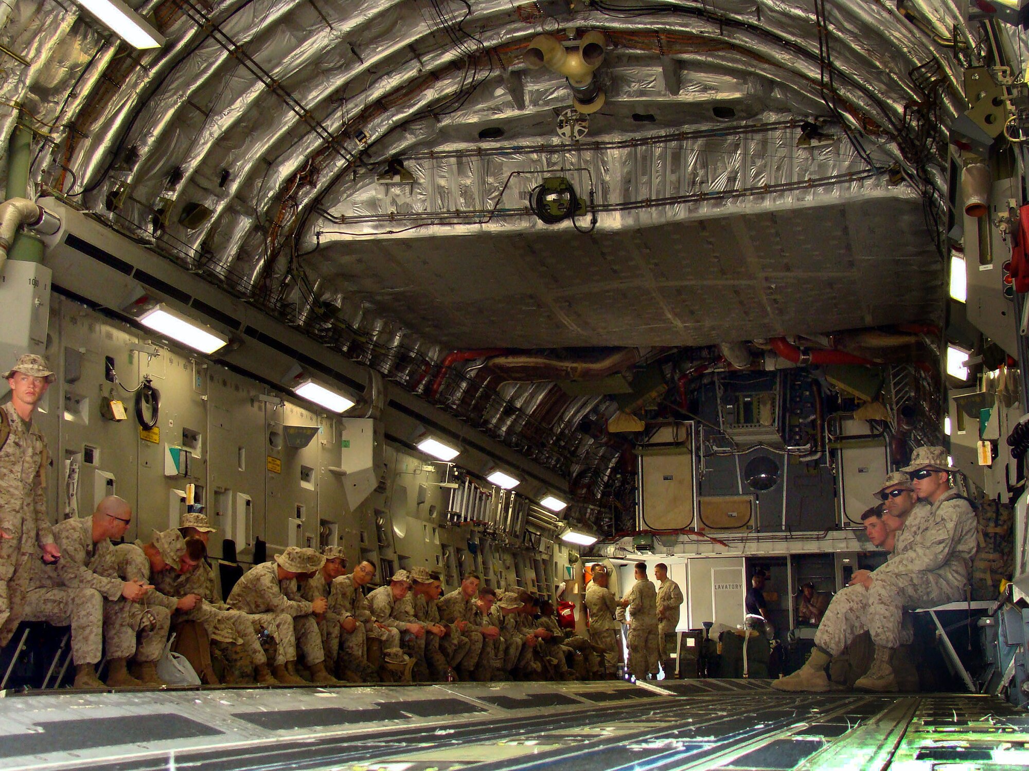 ACCRA, Ghana – U.S. Marine Corps members out of members sit patiently awaiting customs clearance in the bay of the C-17A Globemaster III out of McChord Air Force Base, Washington, Feb. 16. U.S. Armed Forces members are in Accra as part of a joint task force providing infrastructure, aircraft and personnel in support of the President's visits to Benin, Tanzania, Rwanda, Ghana and Liberia Feb. 16 to 21.                          