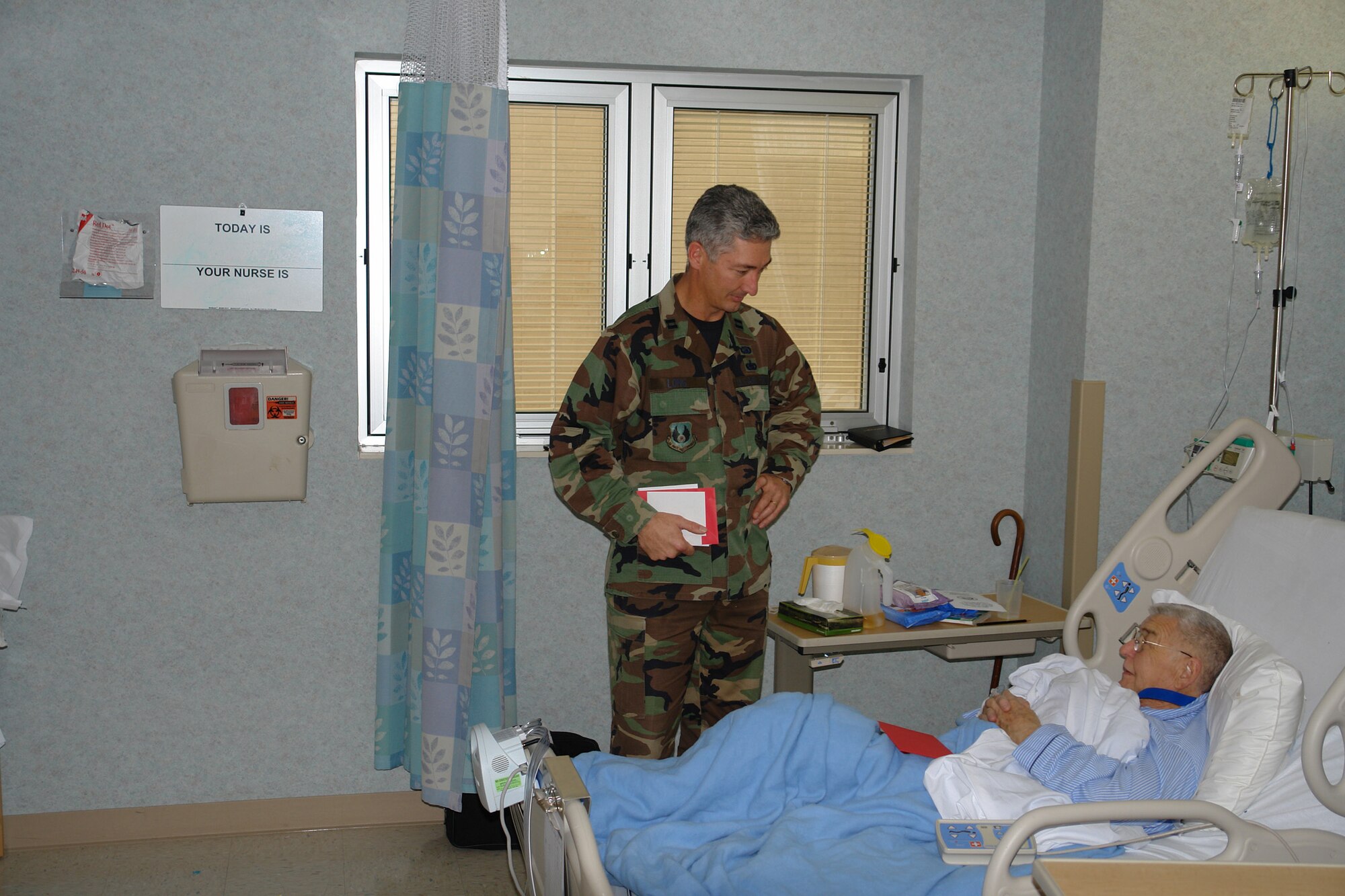 Capt. Jimmy Long, 704th Communications Squadron, visits with a veteran at the Nashville Department of Veterans Affairs (VA) Medical Center Feb. 13. Captain Long volunteered to pay tribute to veterans during National Salute to Hospitalized Veterans Week. (Photo by  1st Lt. Ryan Hawley)