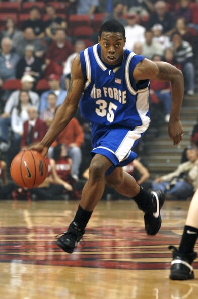 Air Force Academy Cadet Evan Washington, a Falcon point guard, brings the ball up the court during a game against the University of Nevada-Las Vegas Rebels Feb. 12 in Las Vegas.  The Falcons played a hard-fought game but ultimately lost to the Rebels 58-51.  (U.S. Air Force Photo/Master Sgt. Robert W. Valenca)