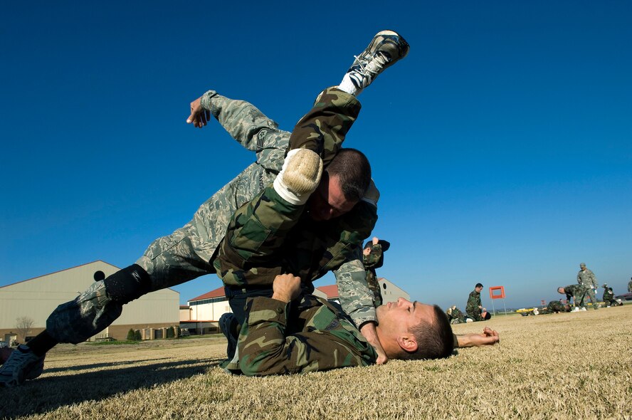Staff Sgt. Christopher Davidson, a military training instructor, demonstrates proper grappling procedures with an officer trainee Feb. 8 during the new Air Force Combative Program field exercise at the Officer Training School at Maxwell Air Force Base, Ala.  (U.S. Air Force photo/Staff Sgt. Bennie J. Davis III)