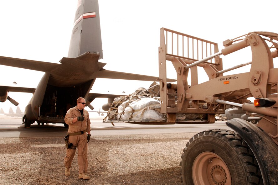 SOUTHWEST ASIA -- Senior Airman Ian Hunt, a C-130 loadmaster deployed with the 737th Expeditionary Airlift Squadron, marshals a 463L cargo pallet onto a C-130 Hercules Feb. 16, 2008, at an air base in the Persian Gulf Region. A part of Airman Hunt's duties as a loadmaster is to ensure the cargo, equipment, and passengers are safely transported to wherever the combatant commanders need them. Airman Hunt is deployed from Dyess Air Force Base, Texas in support of Operations Enduring and Iraqi Freedom. (U.S. Air Force photo/ Staff Sgt. Patrick Dixon)